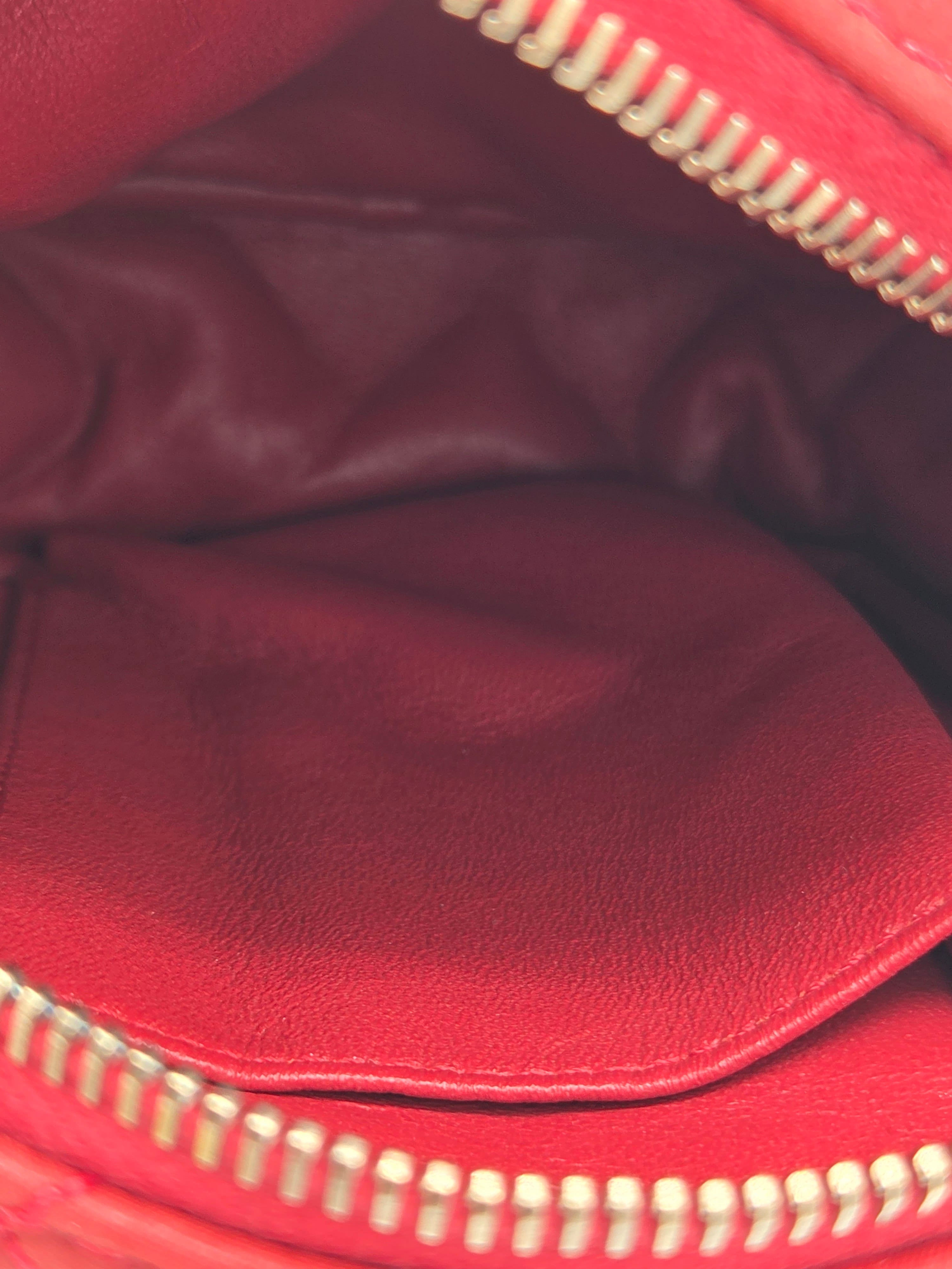 Close-up of a red leather jacket with a zipper