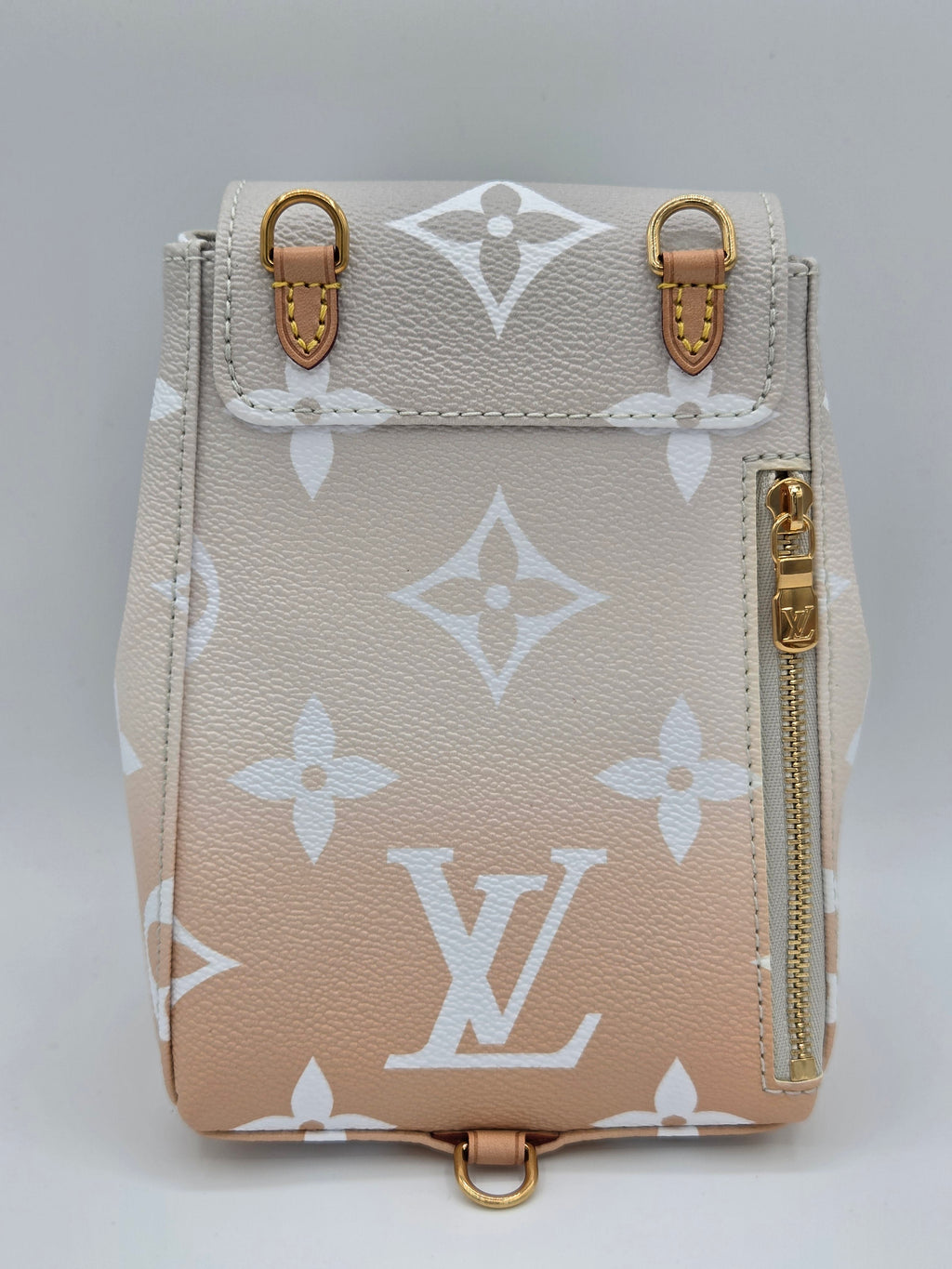 Beige wallet with white monogram pattern on a light gray background