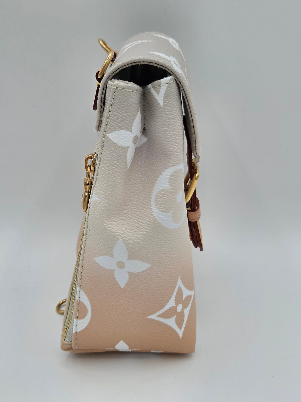 Beige wallet with white logo pattern on a light gray background
