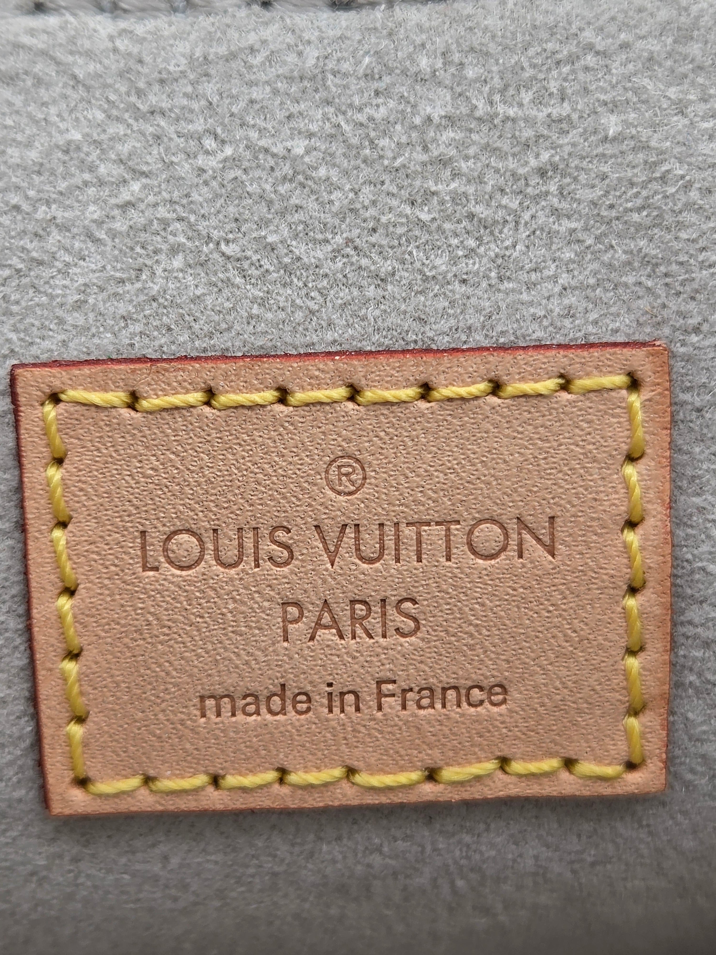 Louis Vuitton label on a textured gray background