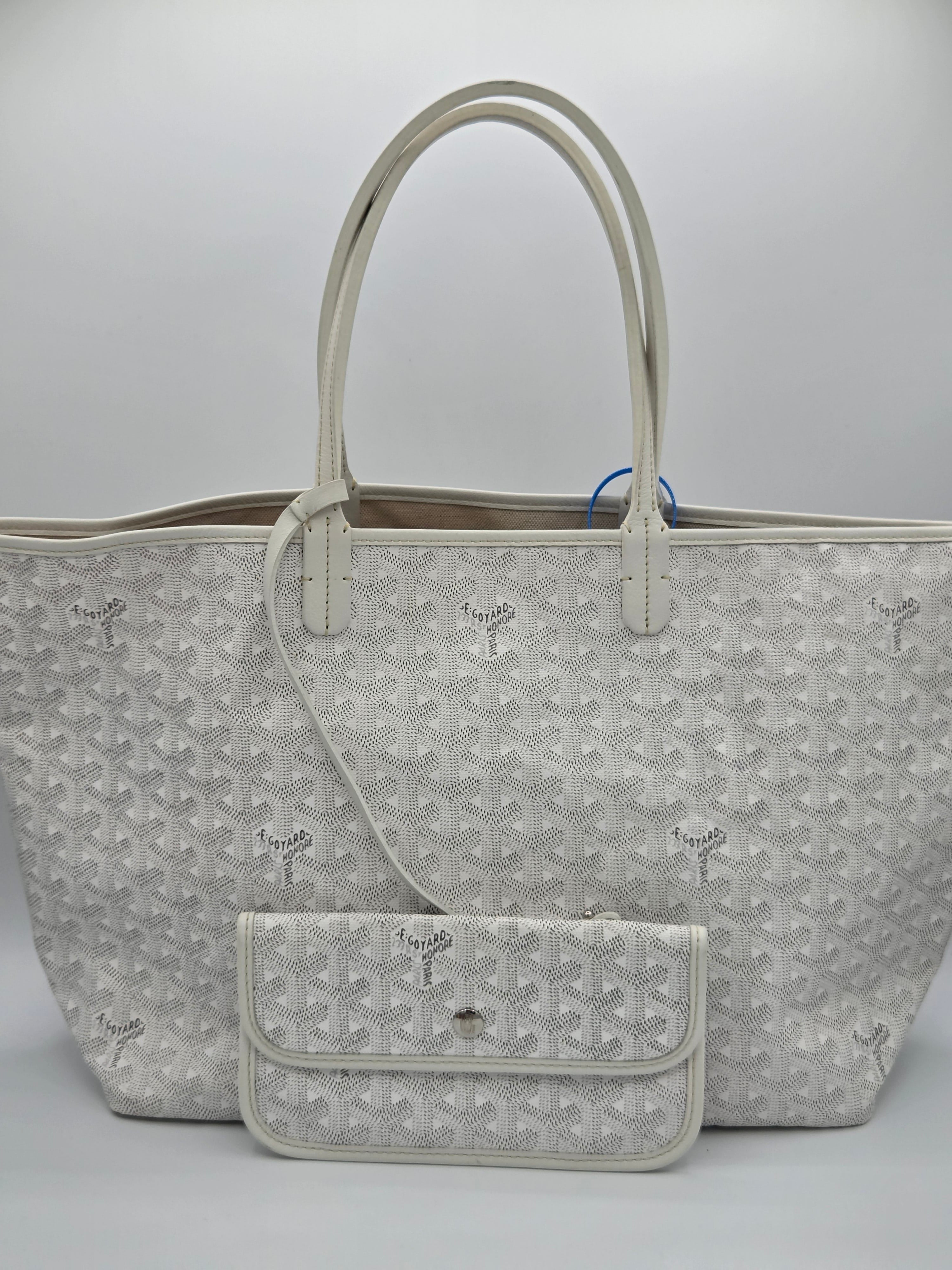 Gray patterned handbag with a smaller pouch on a light gray background