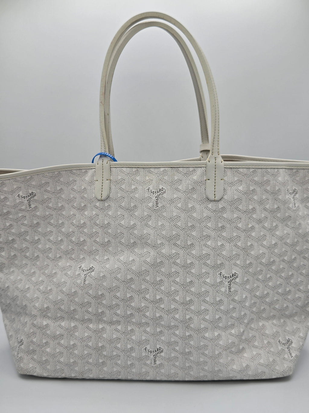 Gray patterned handbag on a light gray background