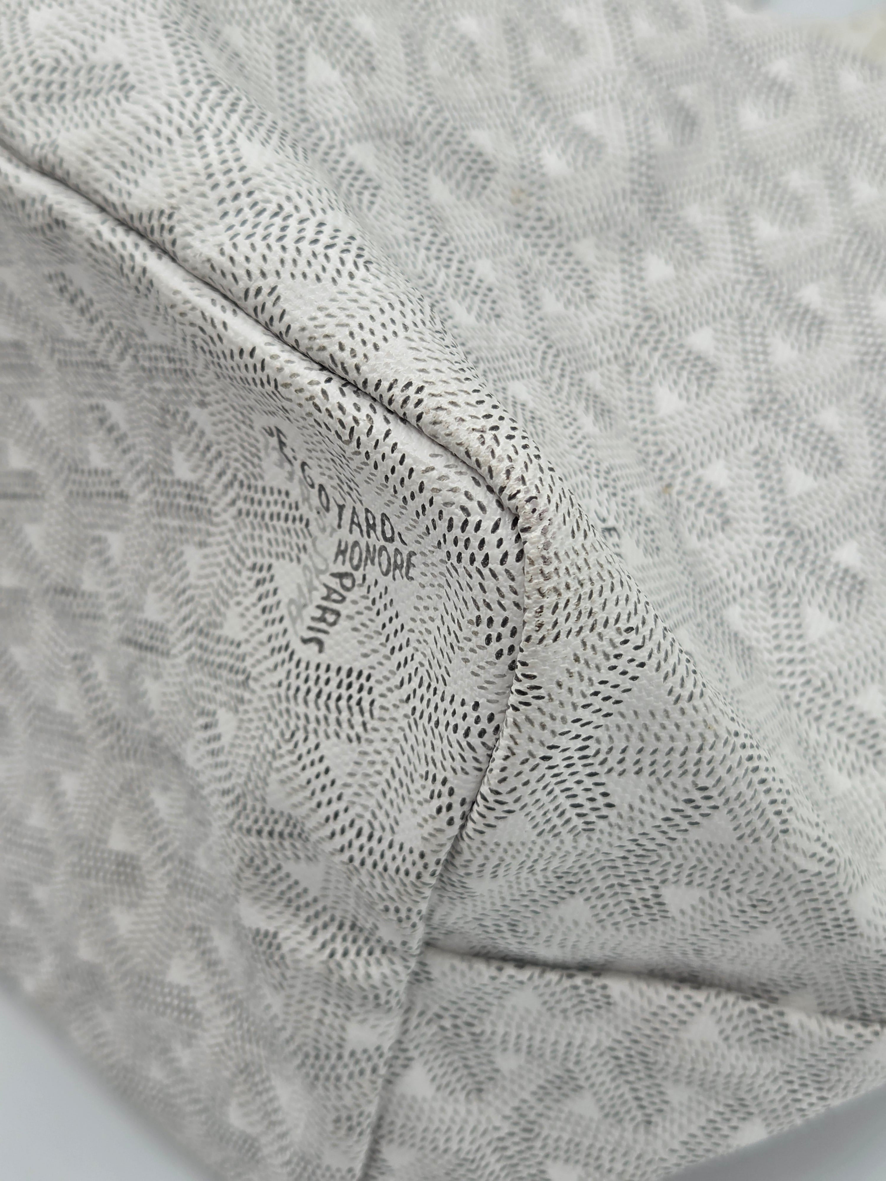 Close-up of a textured fabric with a brand logo on a light gray background