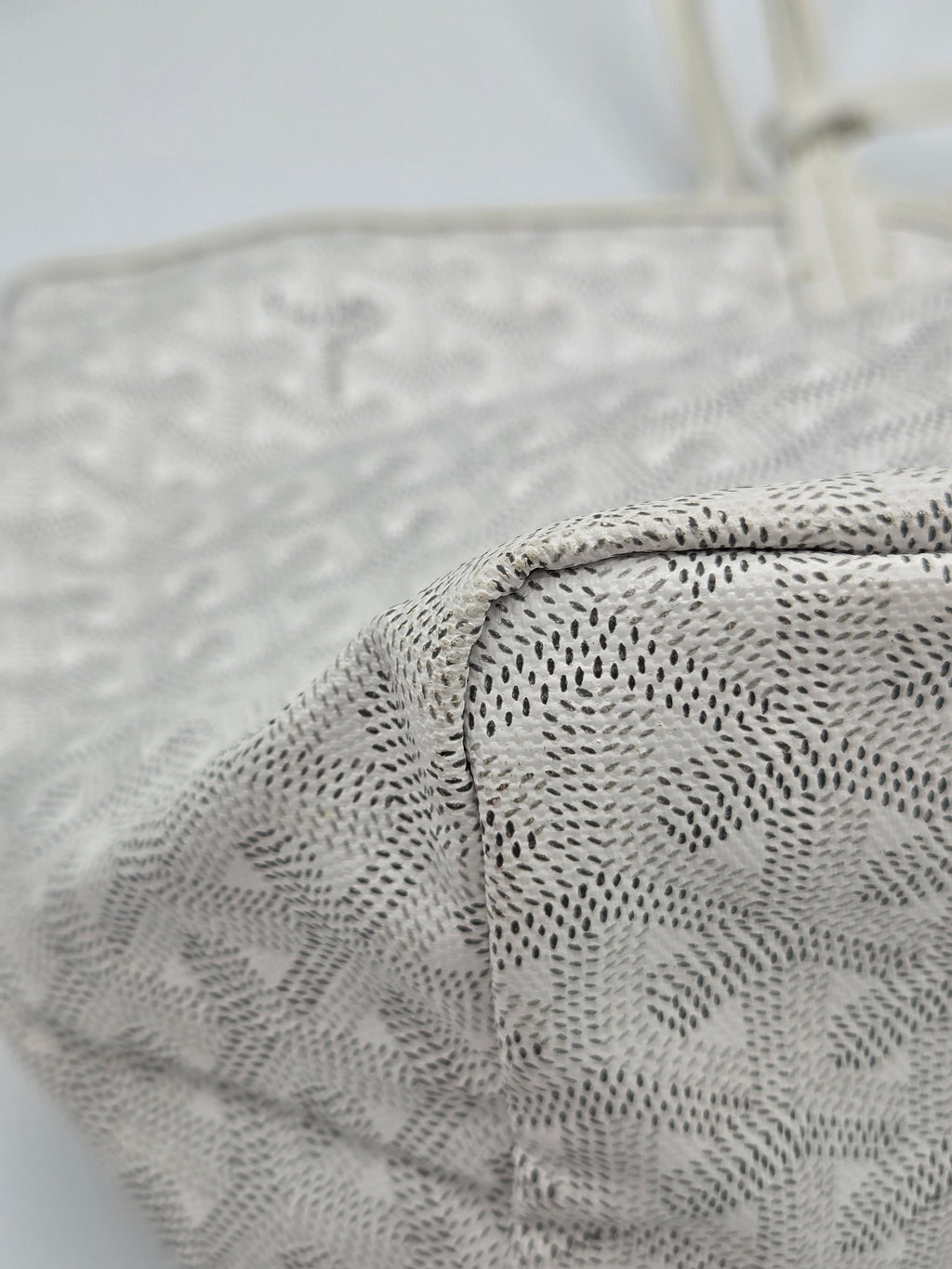 Close-up of a textured gray fabric with a subtle pattern on a light background