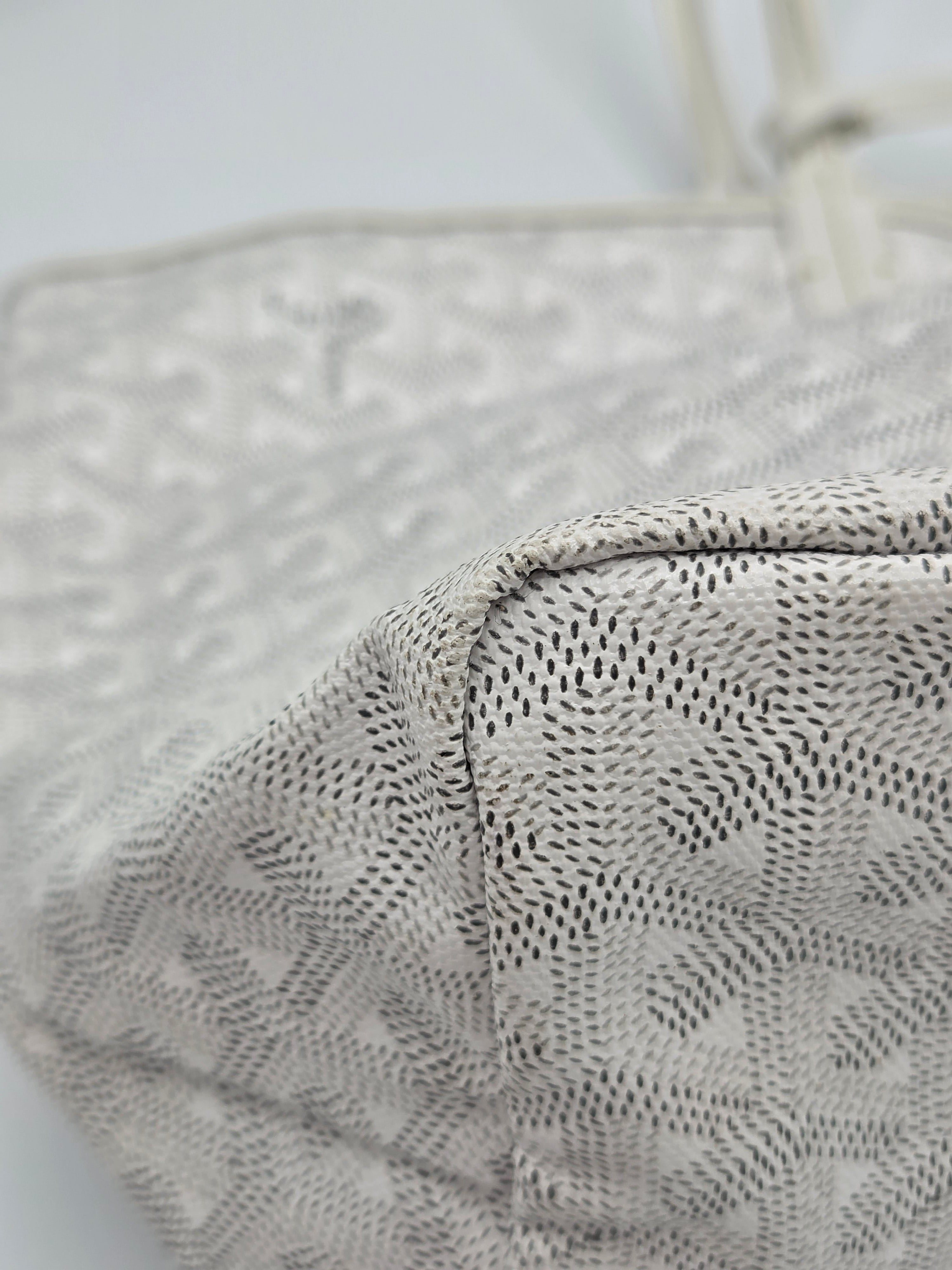 Close-up of a textured gray fabric with a subtle pattern on a light background