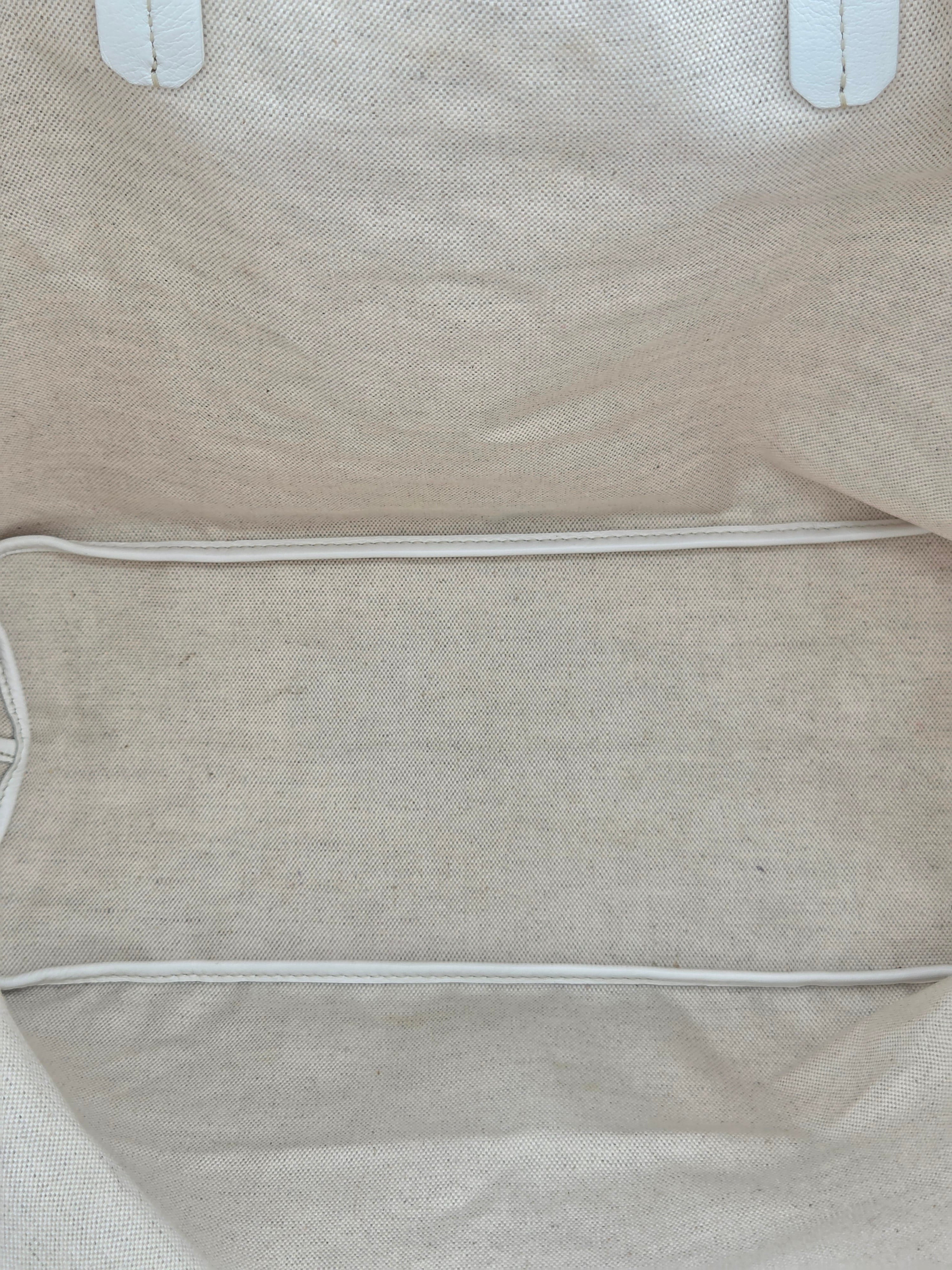 Close-up of a beige fabric bag with visible stitching details.