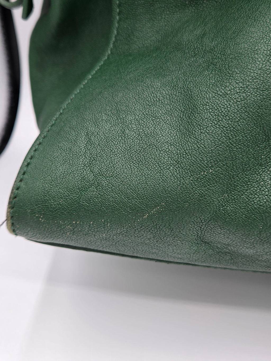 Close-up of green leather surface with visible texture