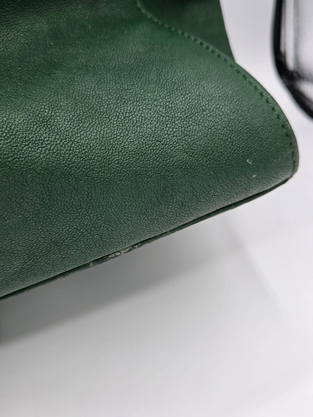 Close-up of a green leather product on a white background