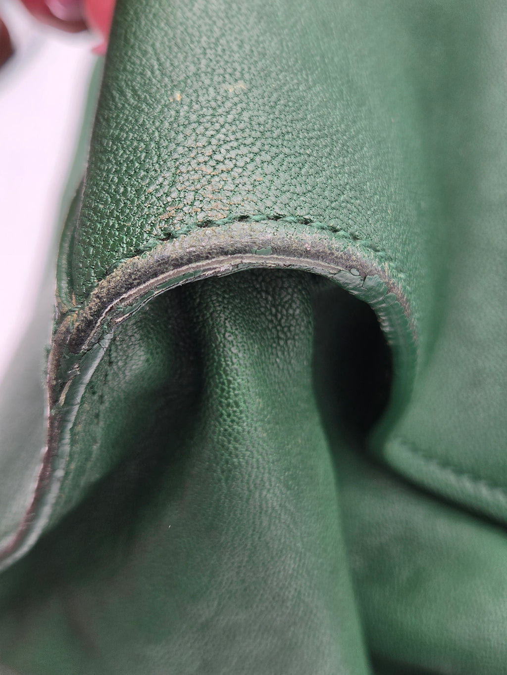 Close-up of green leather with visible stitching