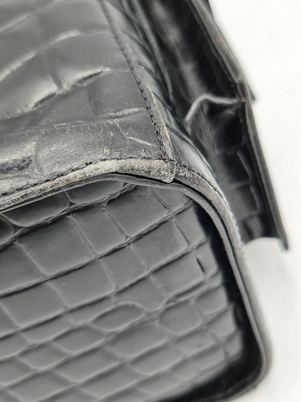 Close-up of a textured car seat cover with a diamond pattern.
