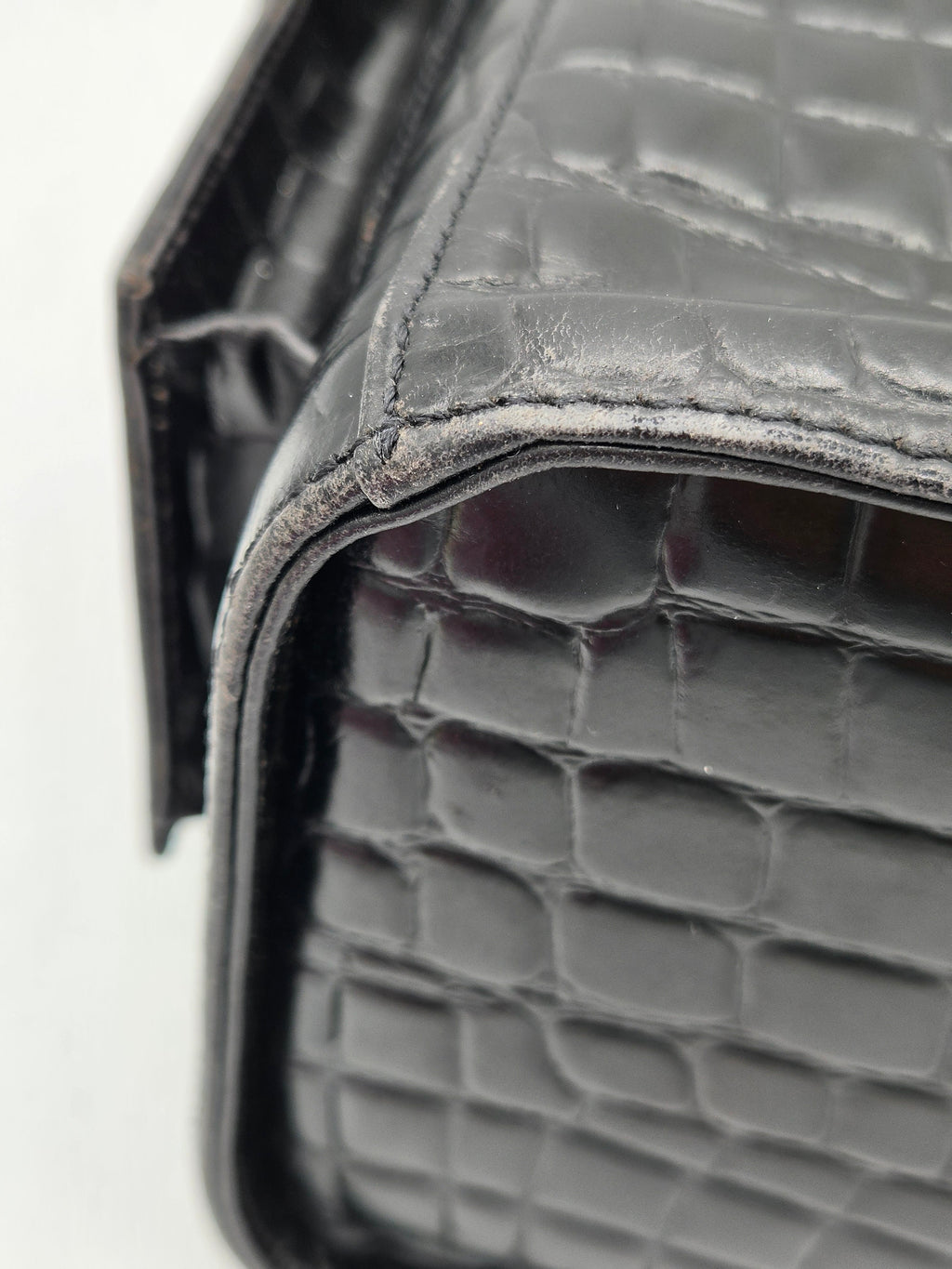 Close-up of a textured black leather product on a white background