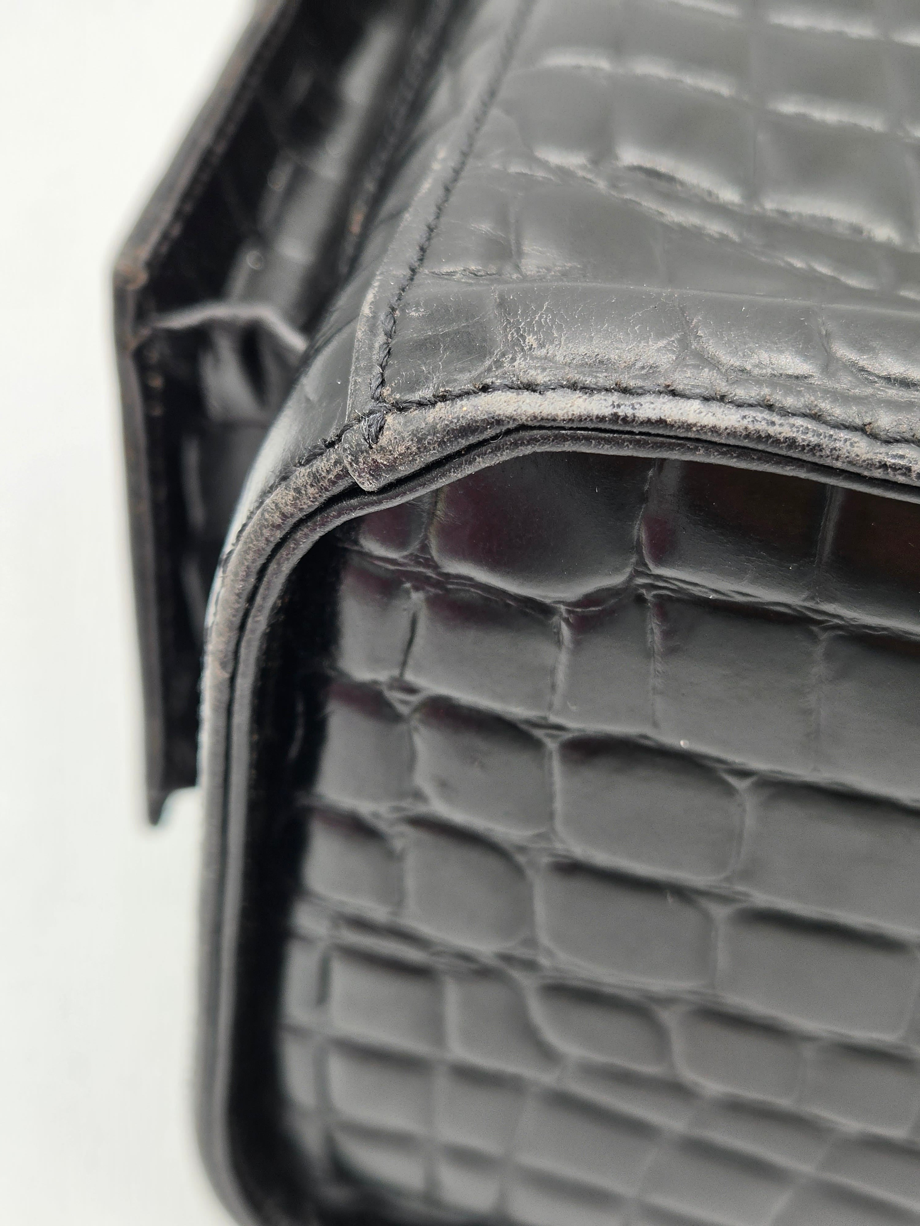 Close-up of a textured black leather product on a white background
