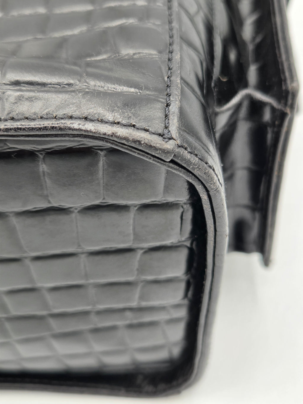 Close-up of a gray textured handbag with a blurred background