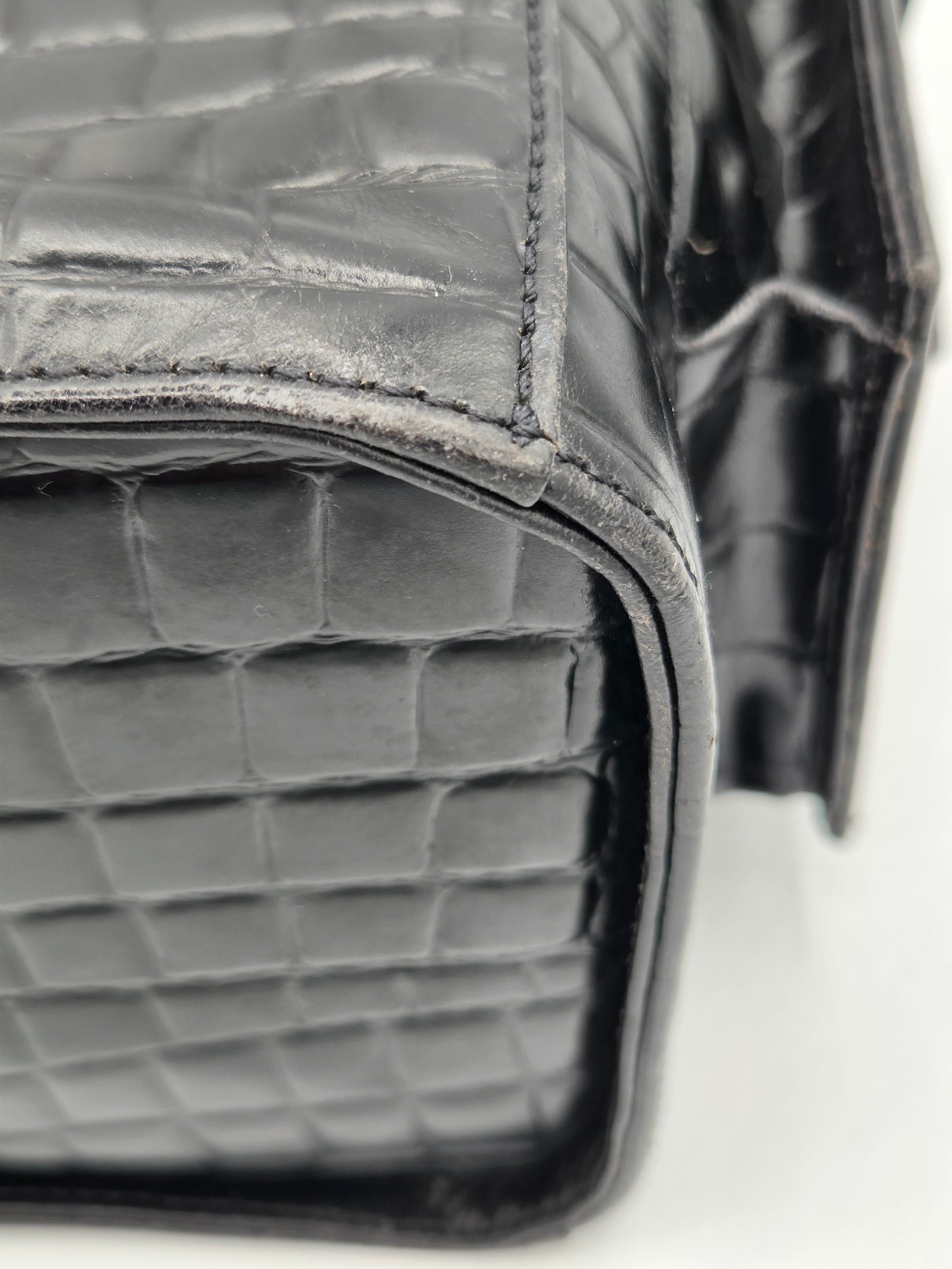 Close-up of a gray textured handbag with a blurred background
