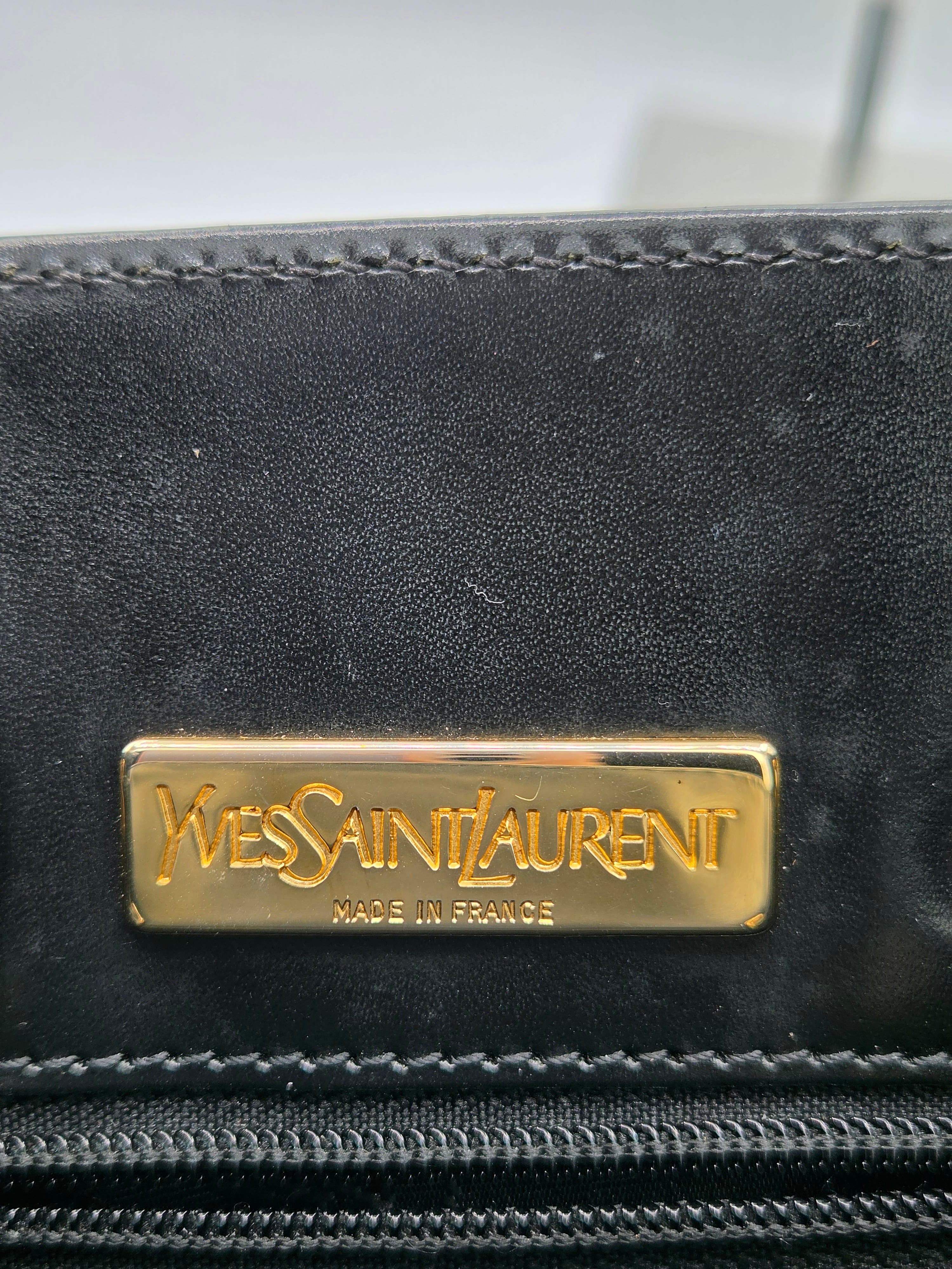 Black leather product with Yves Saint Laurent logo on a blurred background