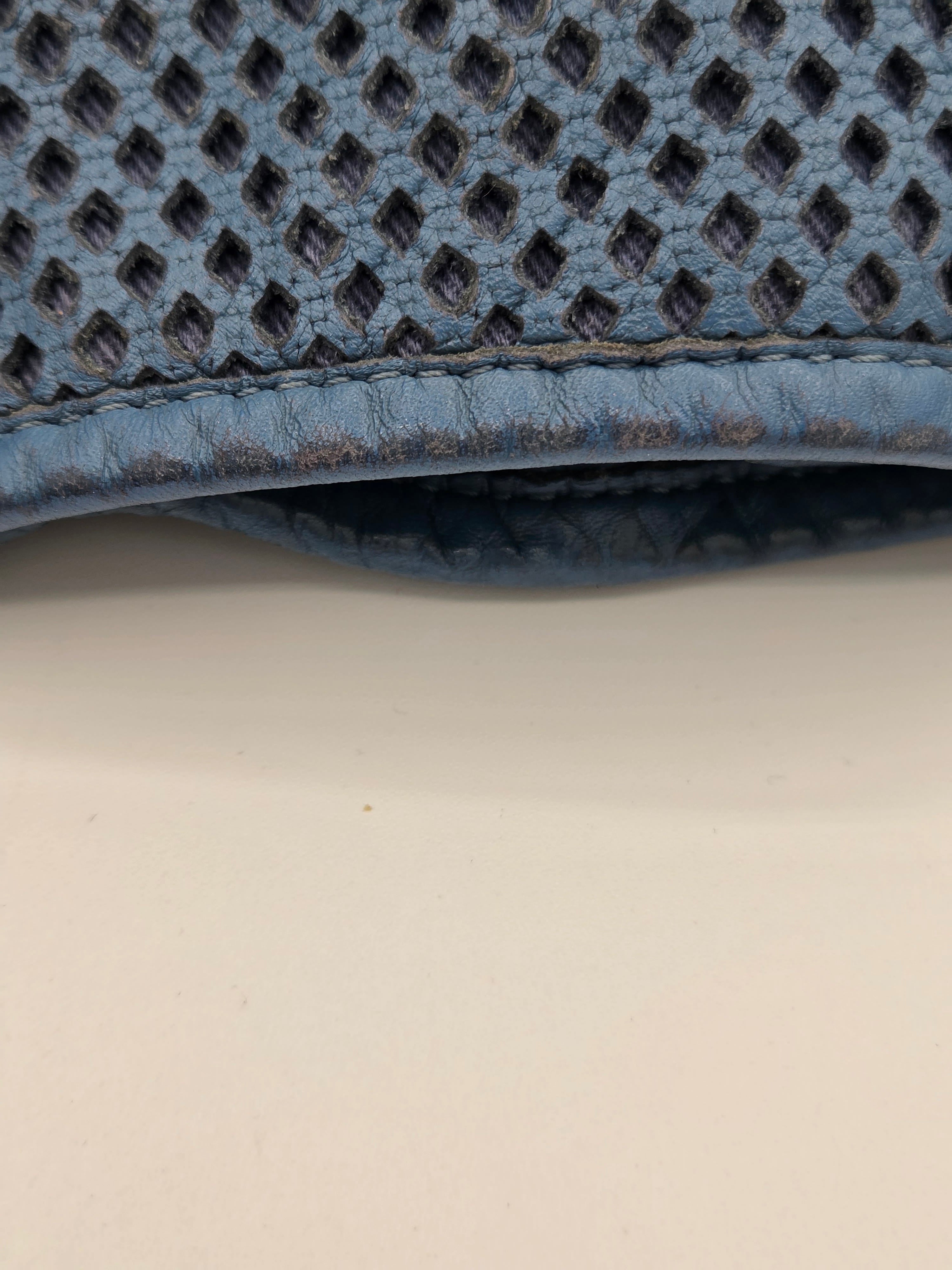 Close-up of a textured blue mat corner on a light beige surface