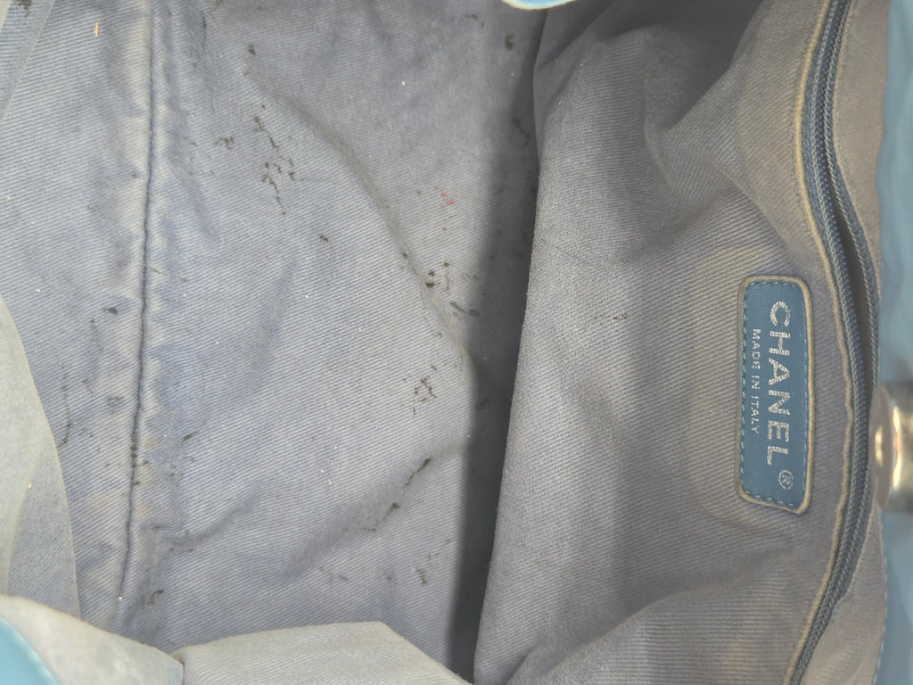 Gray fabric with a Chanel label on a light blue background