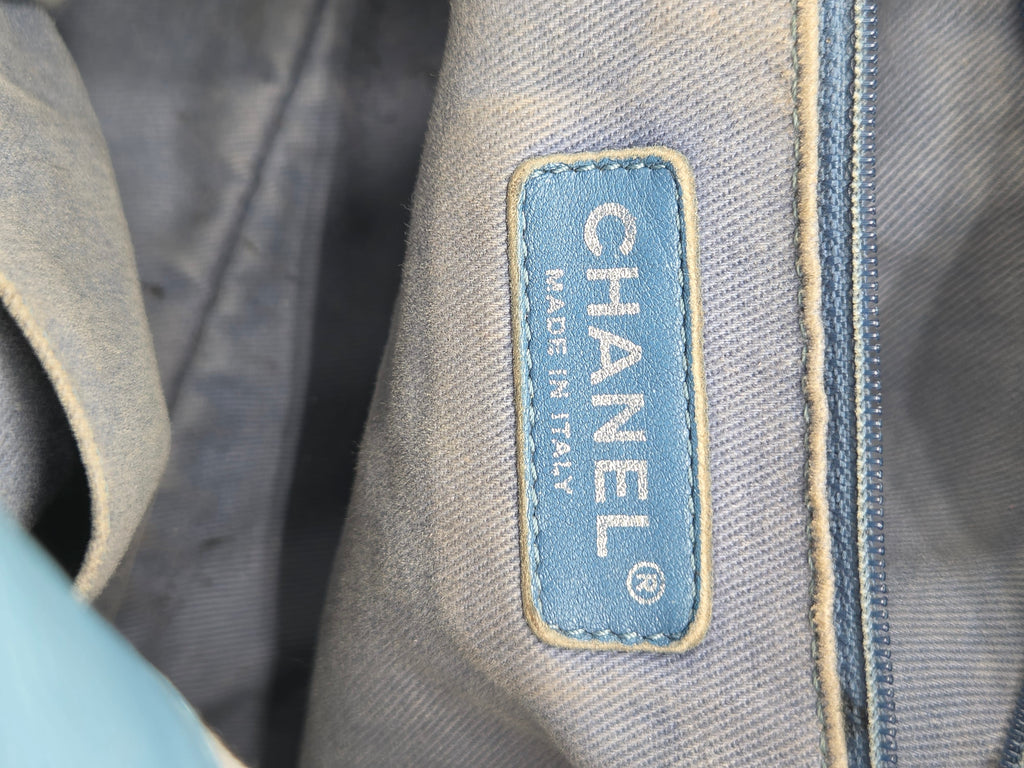 Close-up of a Chanel label on denim fabric.