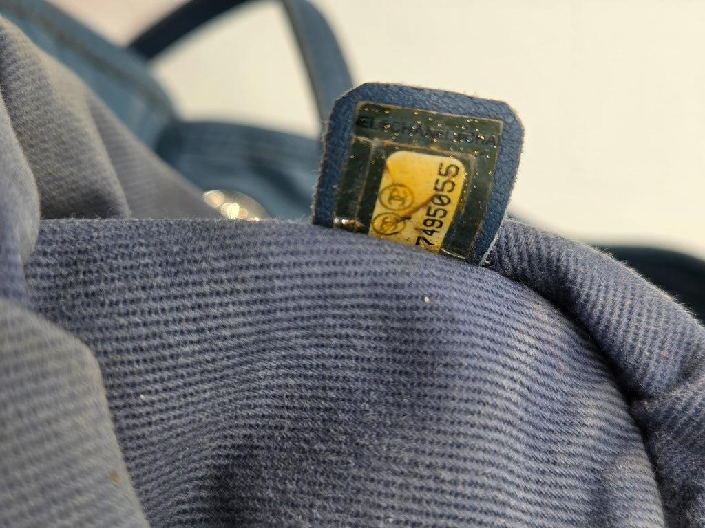 Close-up of a blue textured fabric with a visible brand label.