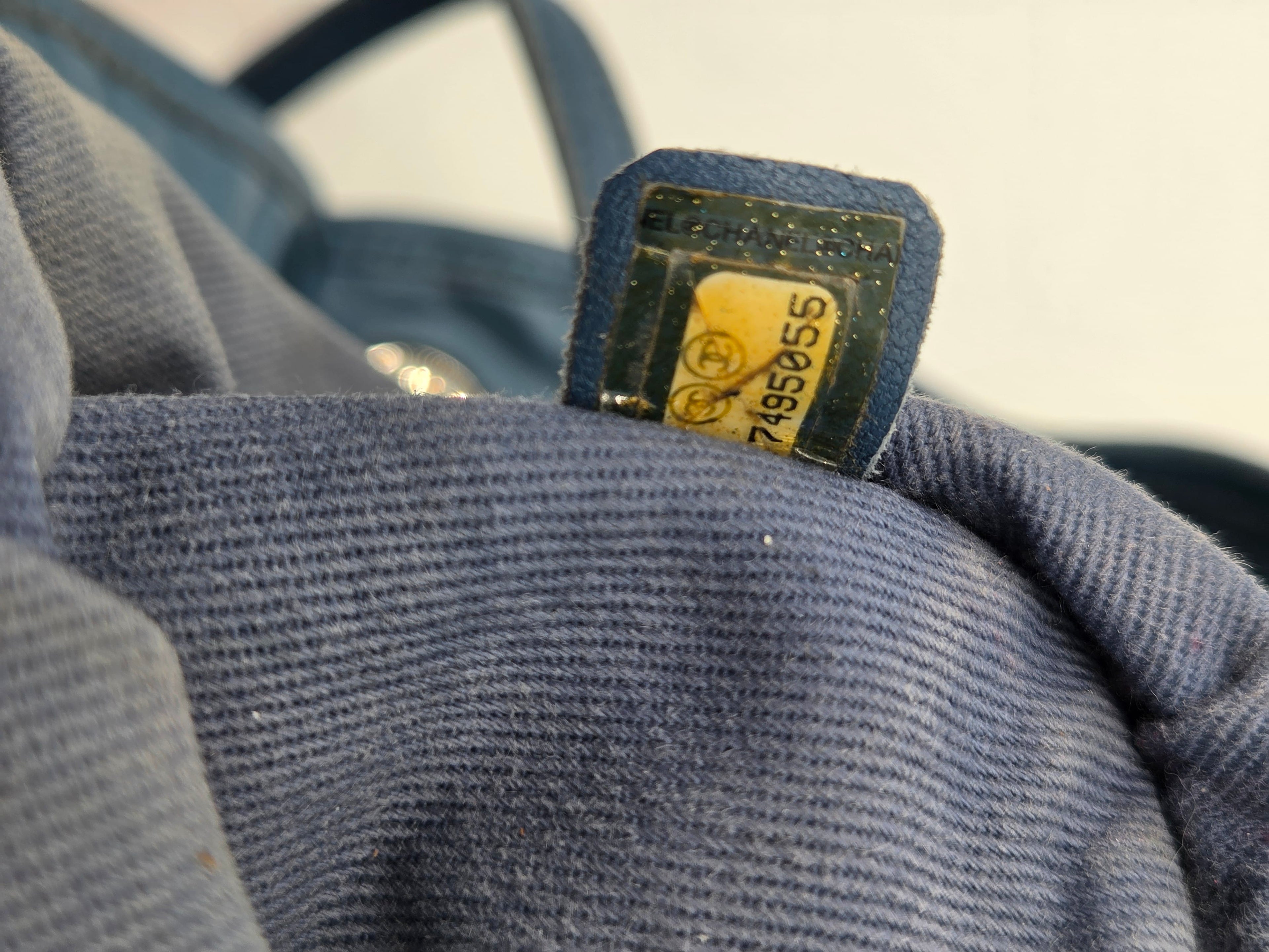 Close-up of a blue textured fabric with a visible brand label.