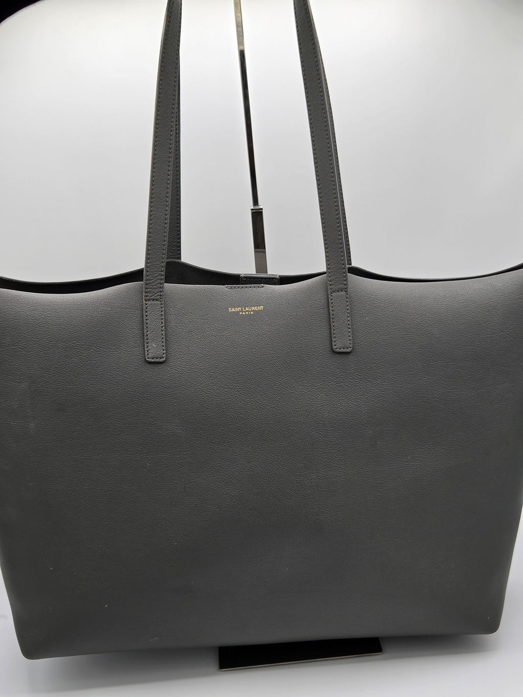 Black tote bag with visible brand name on a white background