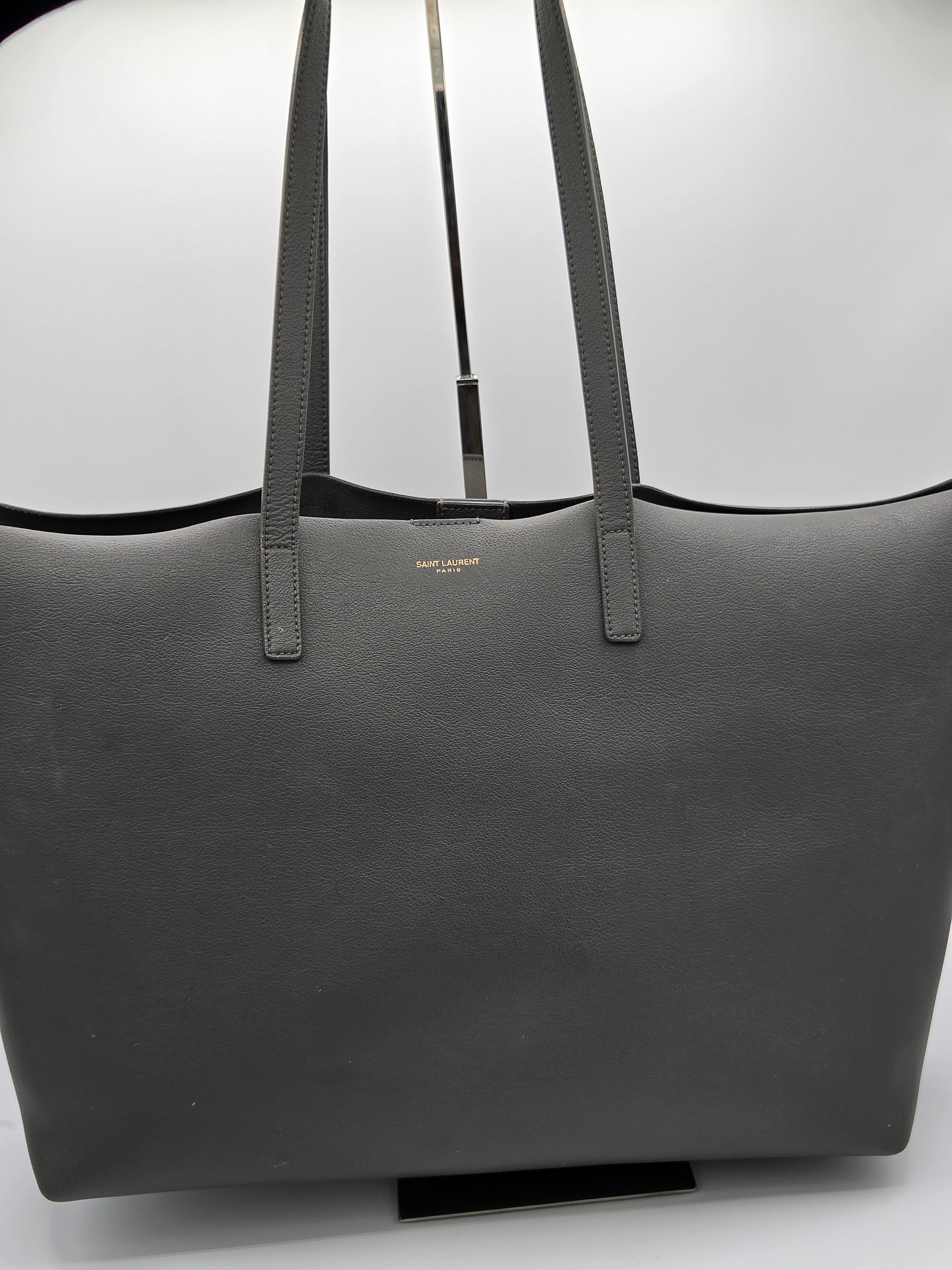 Black tote bag with visible brand name on a white background