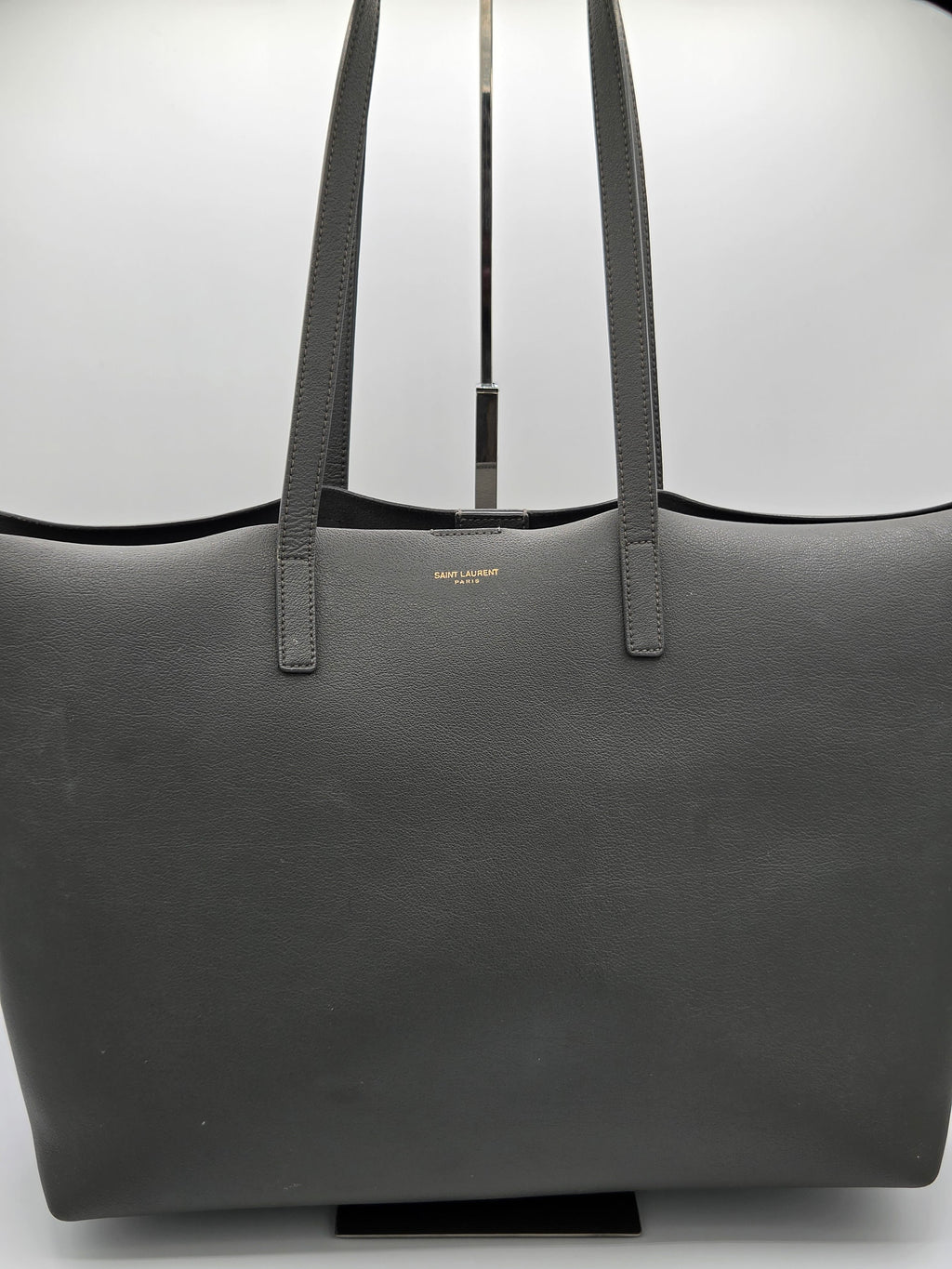 Black leather bag with shoulder straps on a white background