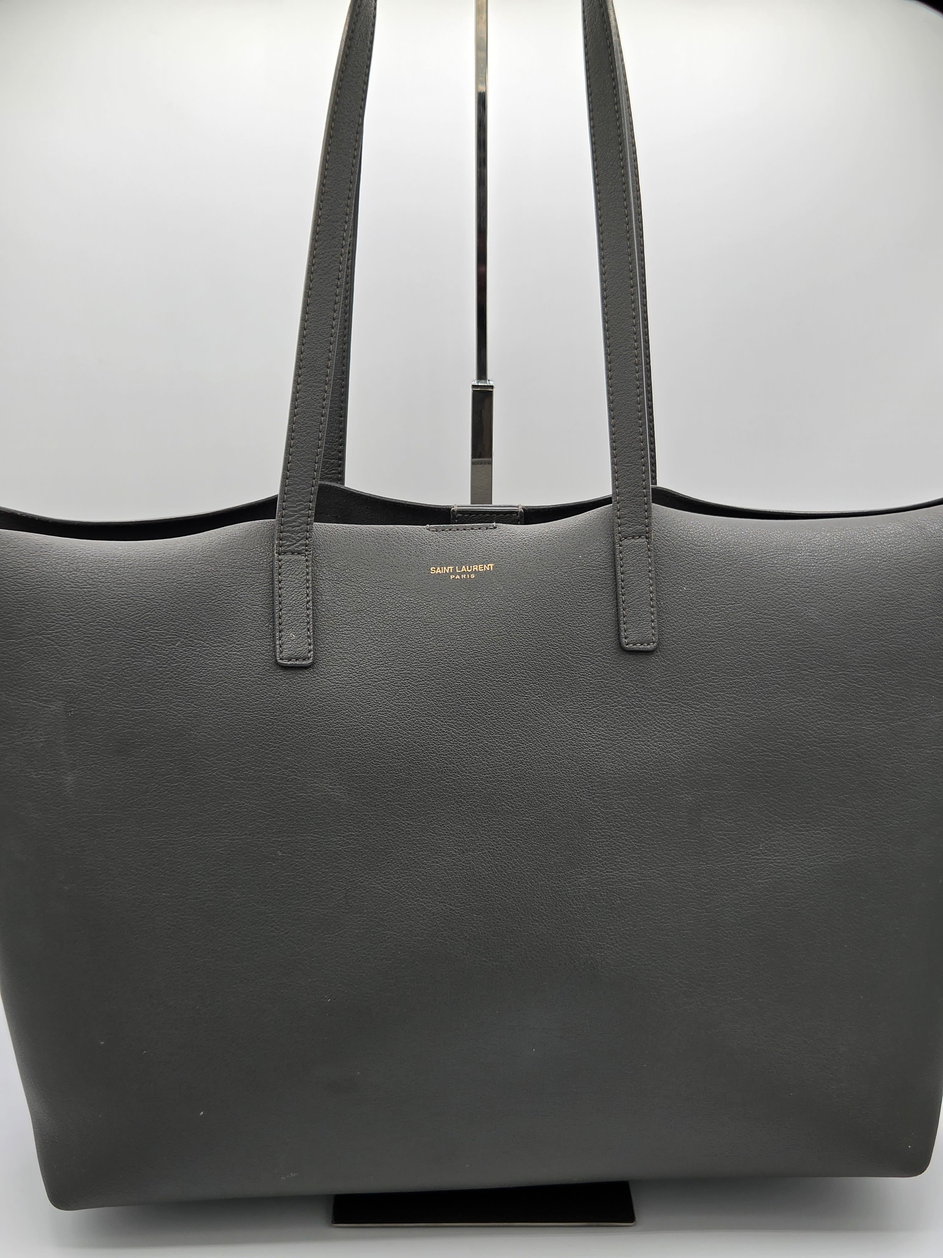Black leather bag with shoulder straps on a white background