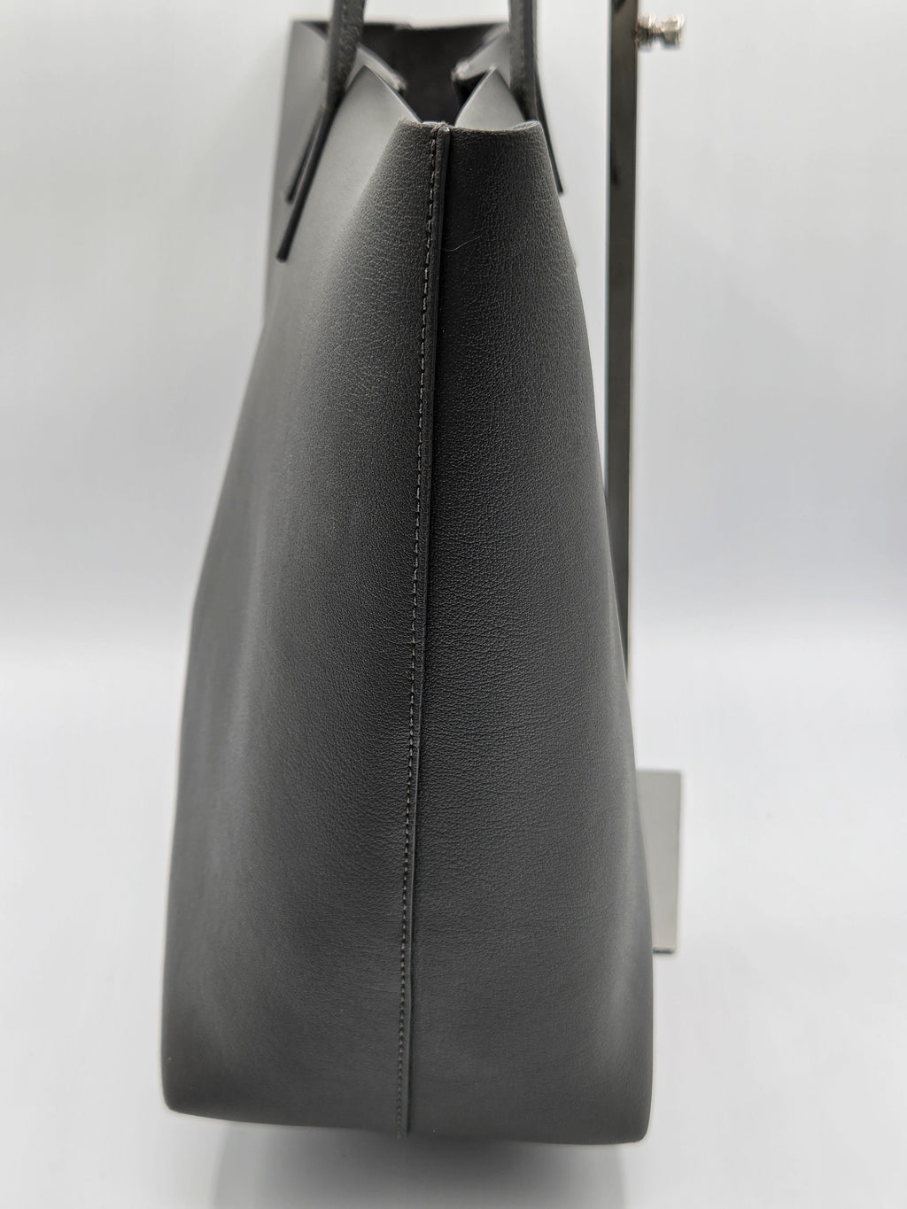Black leather clutch bag on a white background