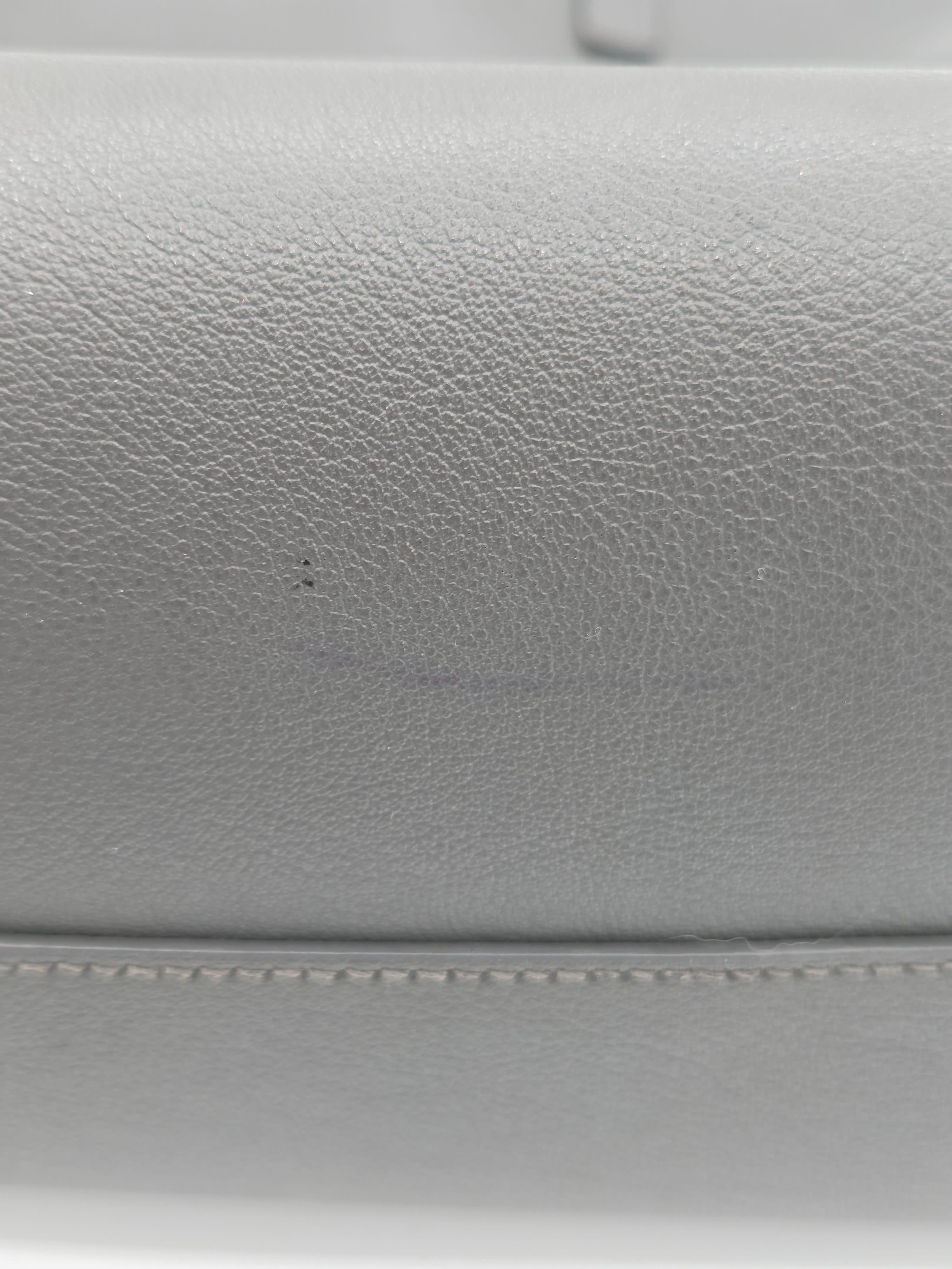 Close-up of gray leather surface with stitching detail