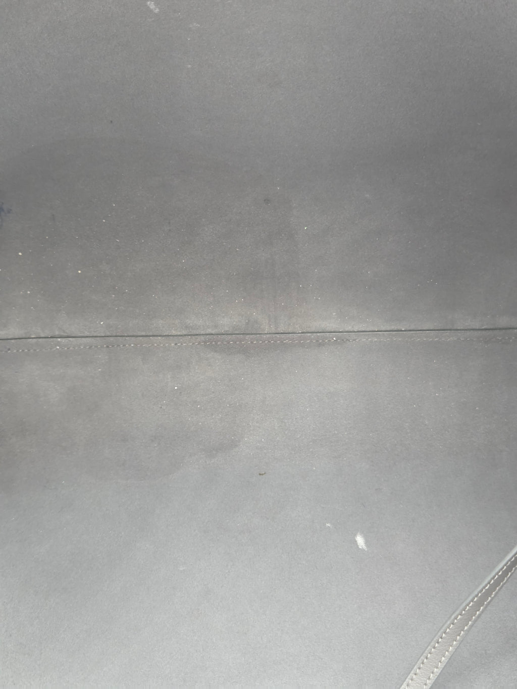 Close-up of a gray fabric surface with a seam