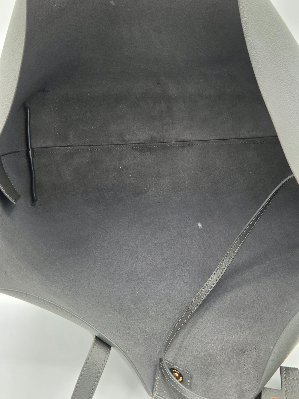 Close-up of a car seat with visible wear and tear on a white background