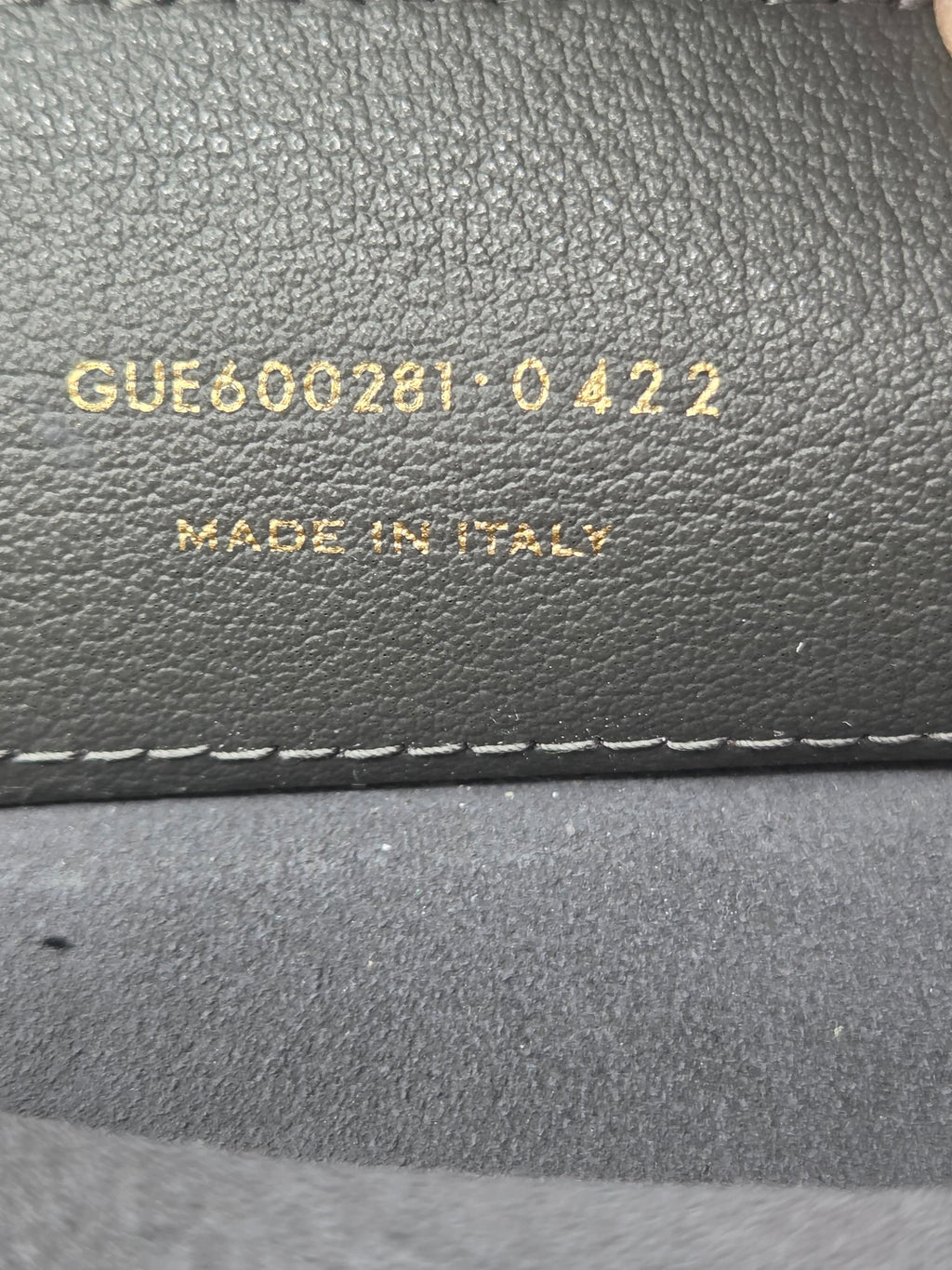 Close-up of a textured gray surface with visible stitching and 'Made in Italy' text.