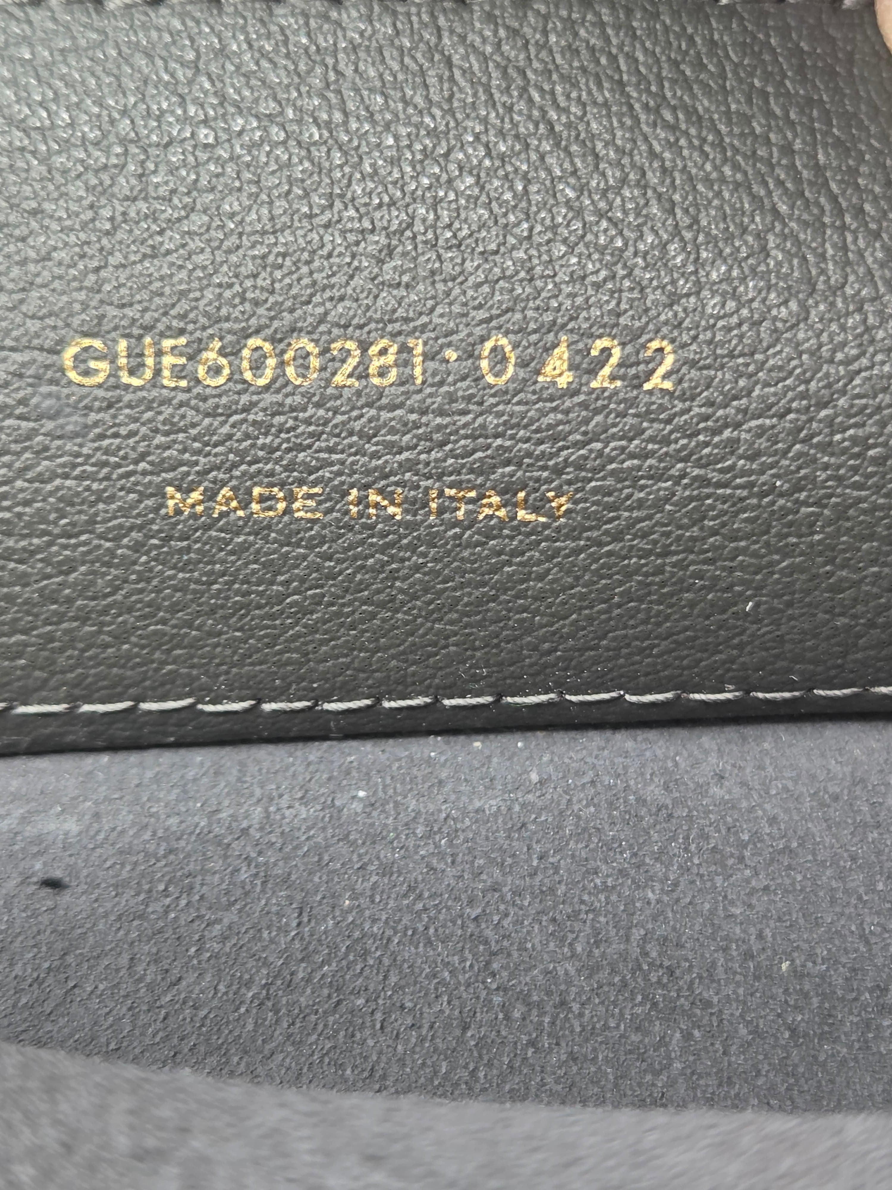 Close-up of a textured gray surface with visible stitching and 'Made in Italy' text.