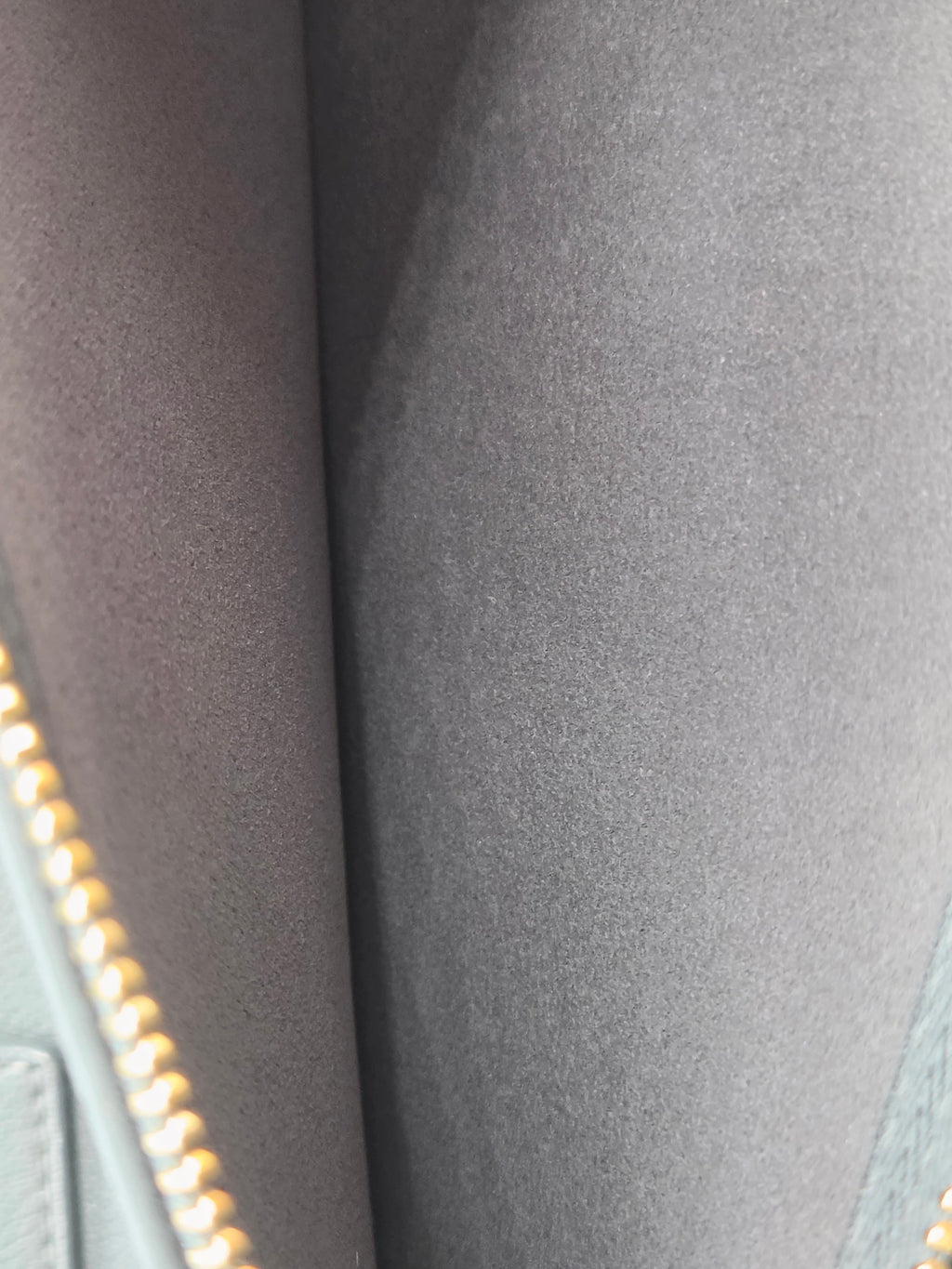 Close-up of a textured gray fabric with a zipper