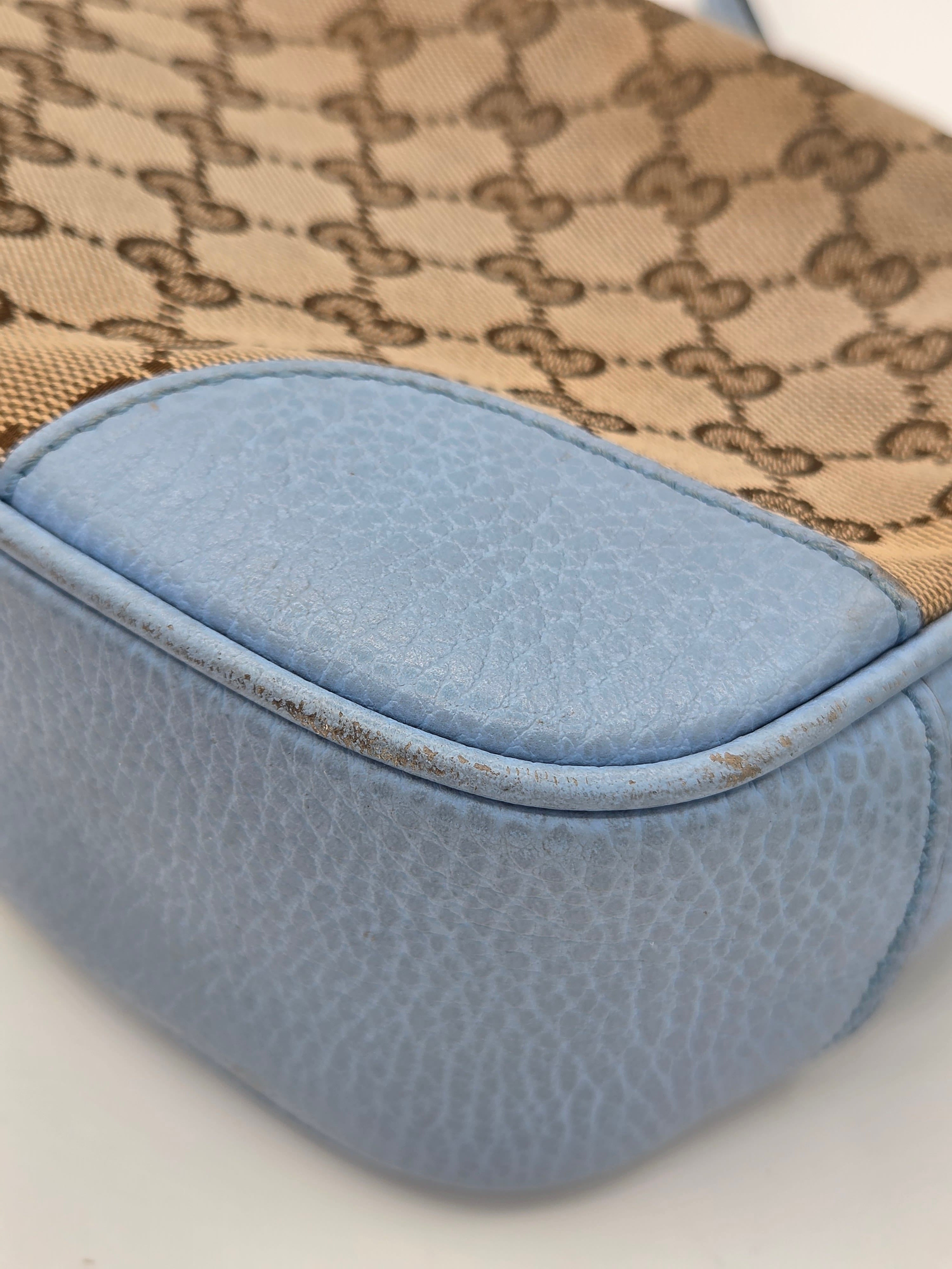 Close-up of a patterned fabric with a blue patch on a neutral background