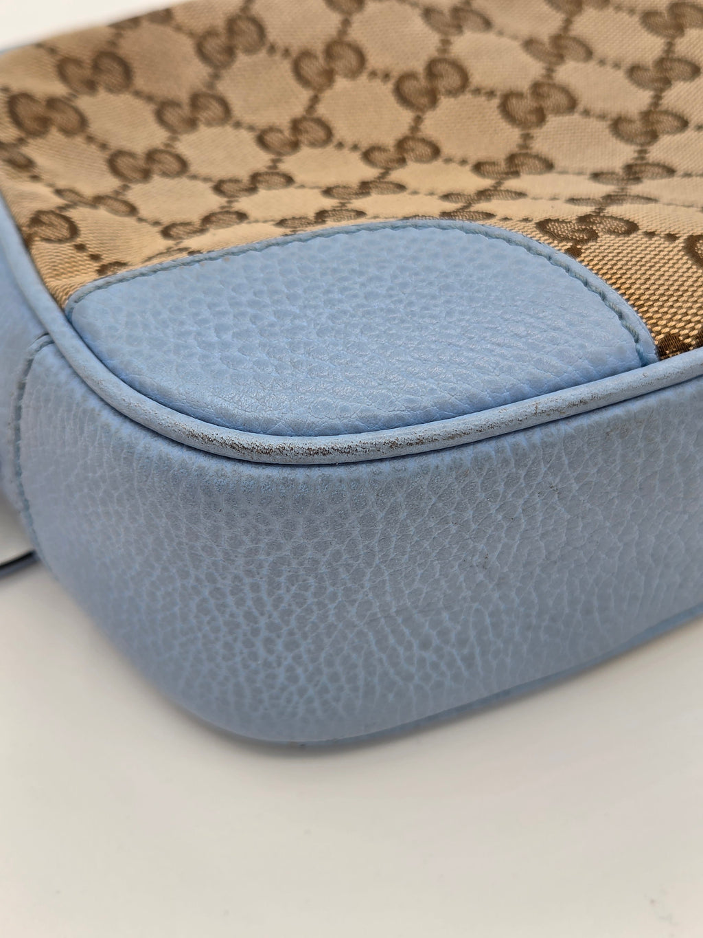 Close-up of a blue textured product with a patterned fabric background
