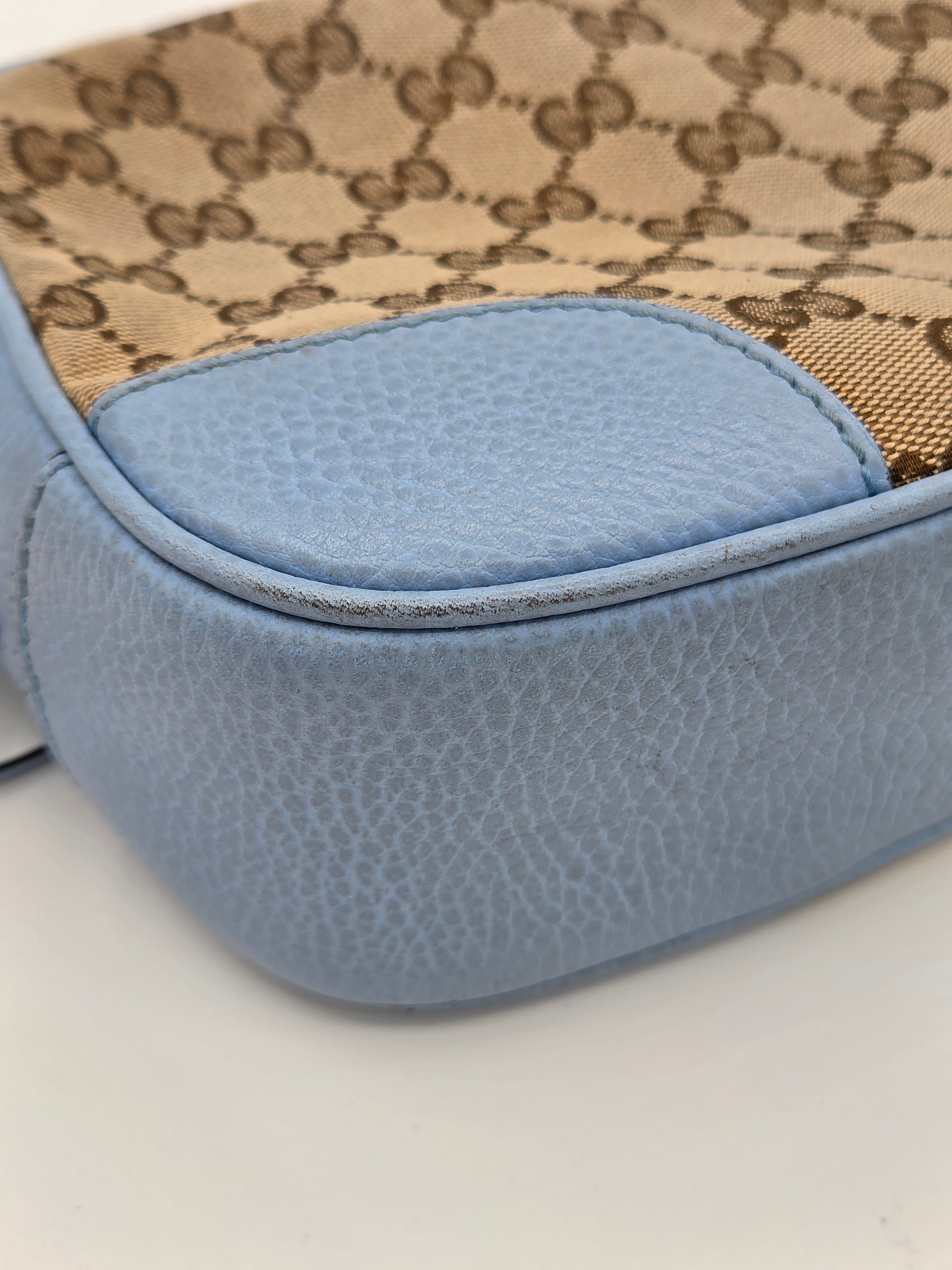 Close-up of a blue textured product with a patterned fabric background