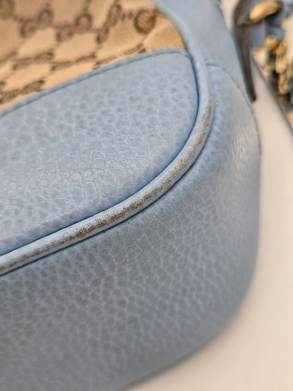 Close-up of a textured blue surface with a blurred pattern in the background