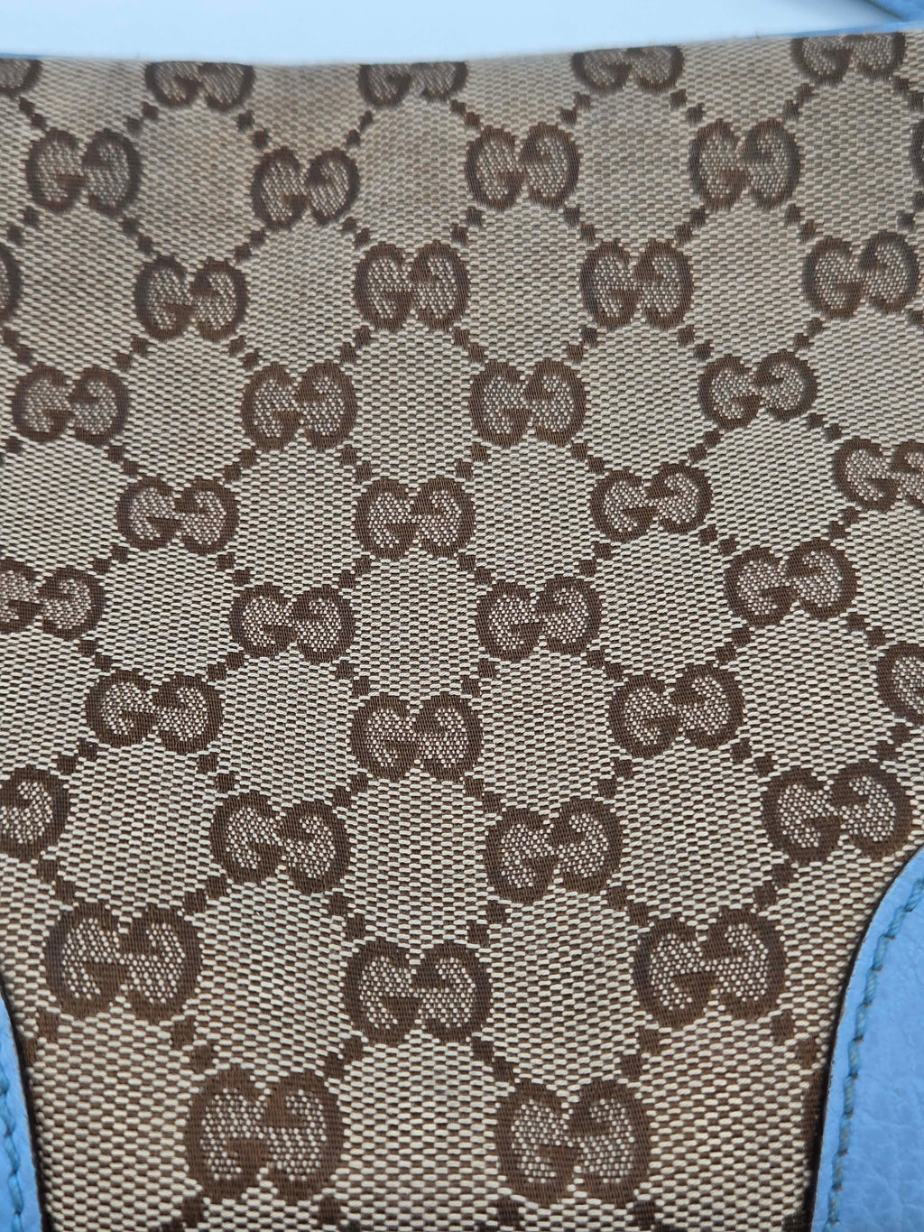 Close-up of a patterned fabric with brown and beige design on a blue background