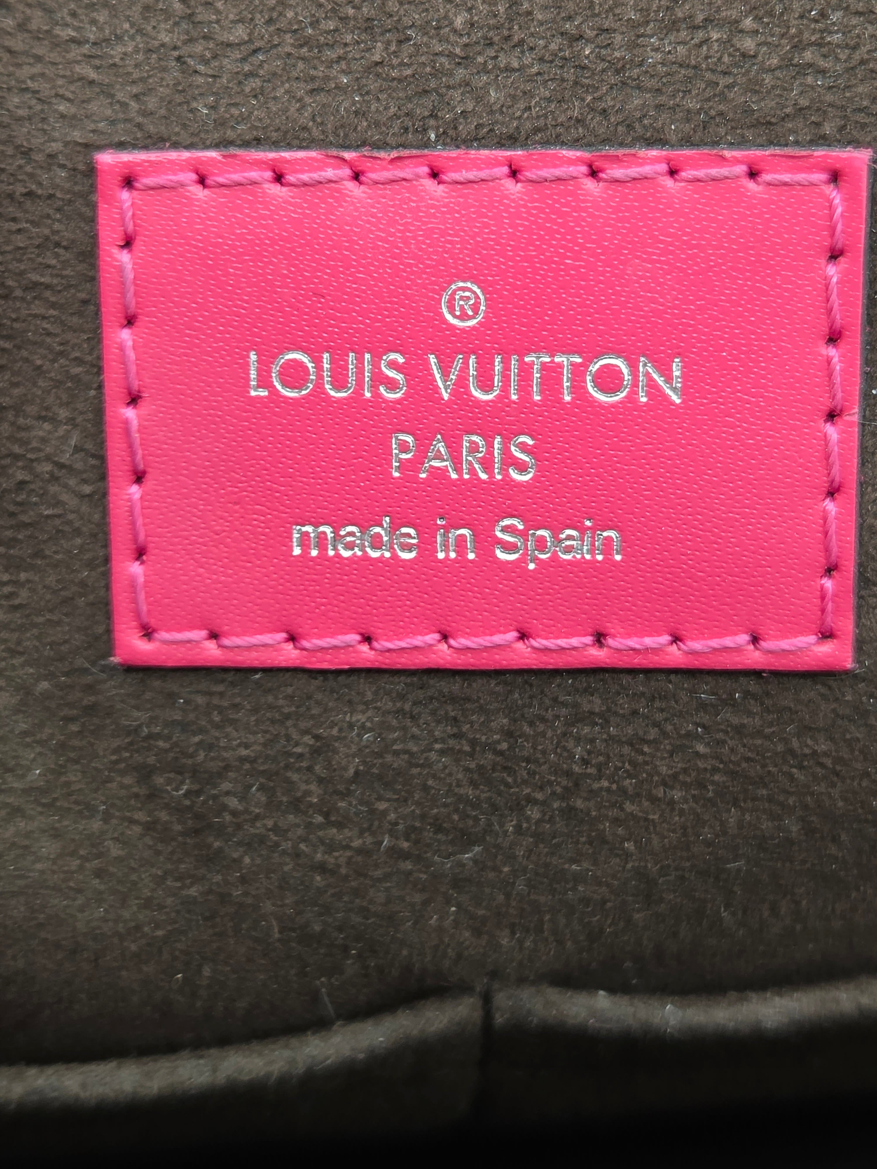 Pink Louis Vuitton label on a dark background