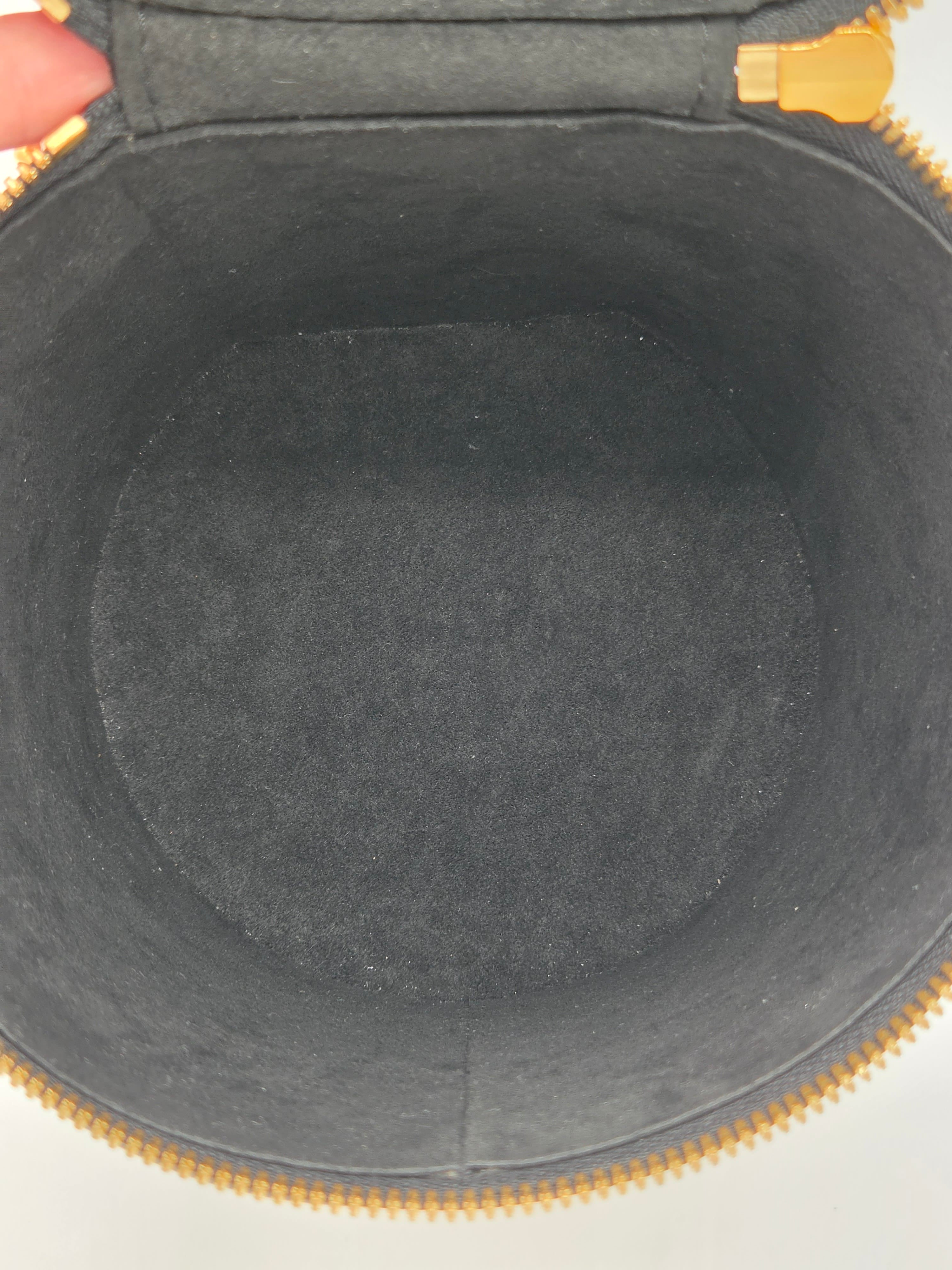 Close-up of a gray interior of a bag with gold zipper.