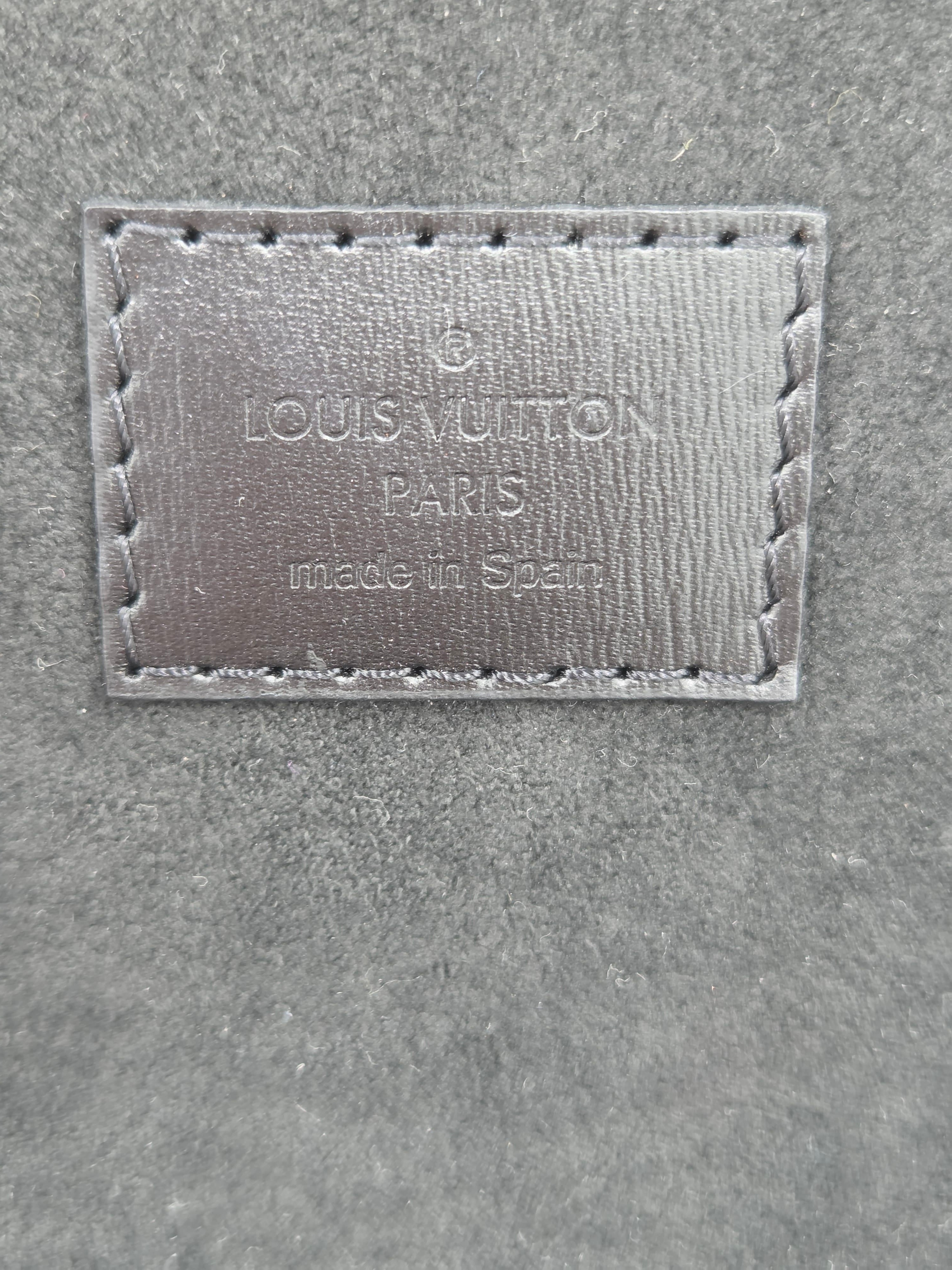 Louis Vuitton label on a textured surface
