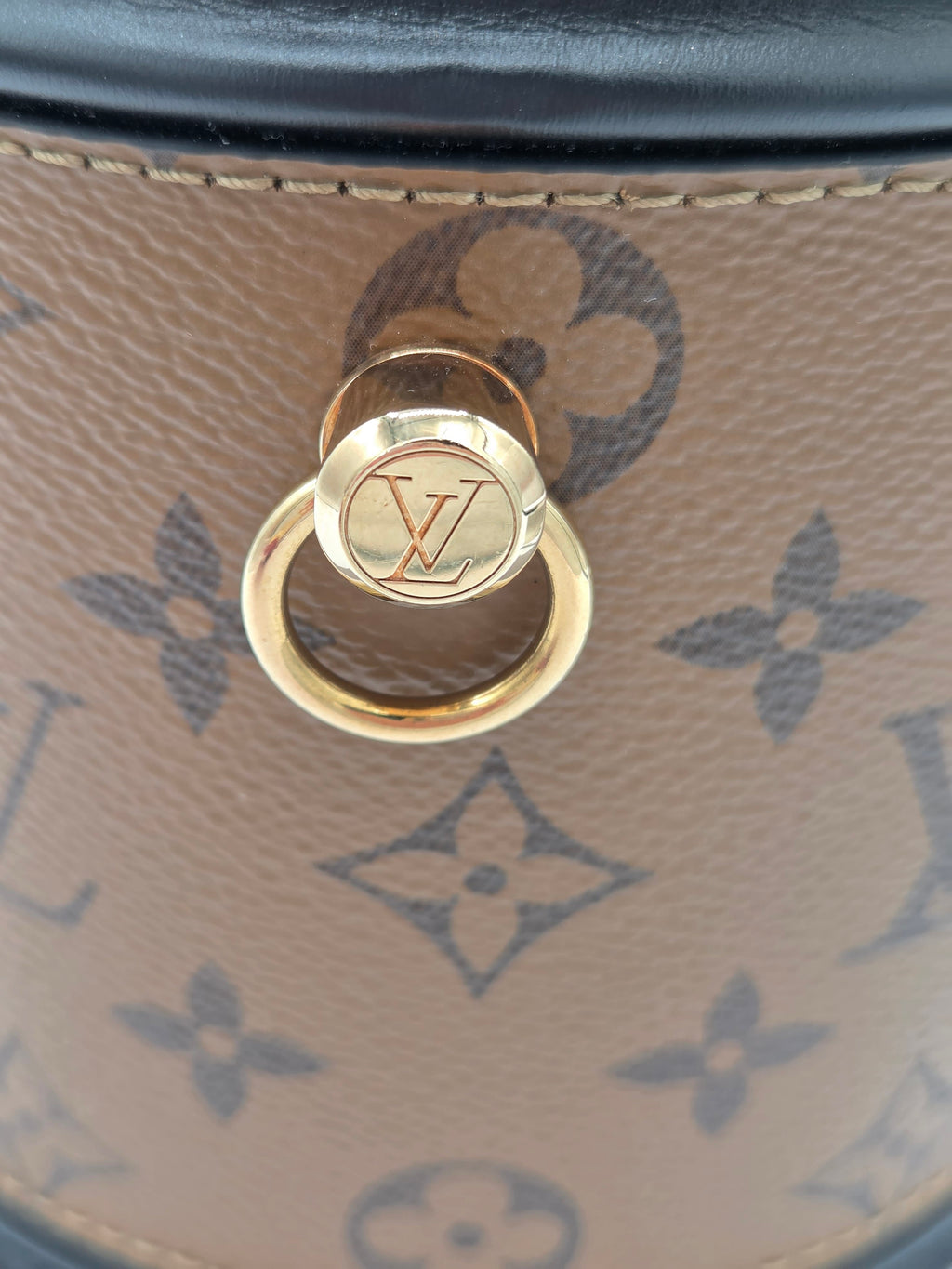 Gold lock on a Louis Vuitton handbag with monogram pattern