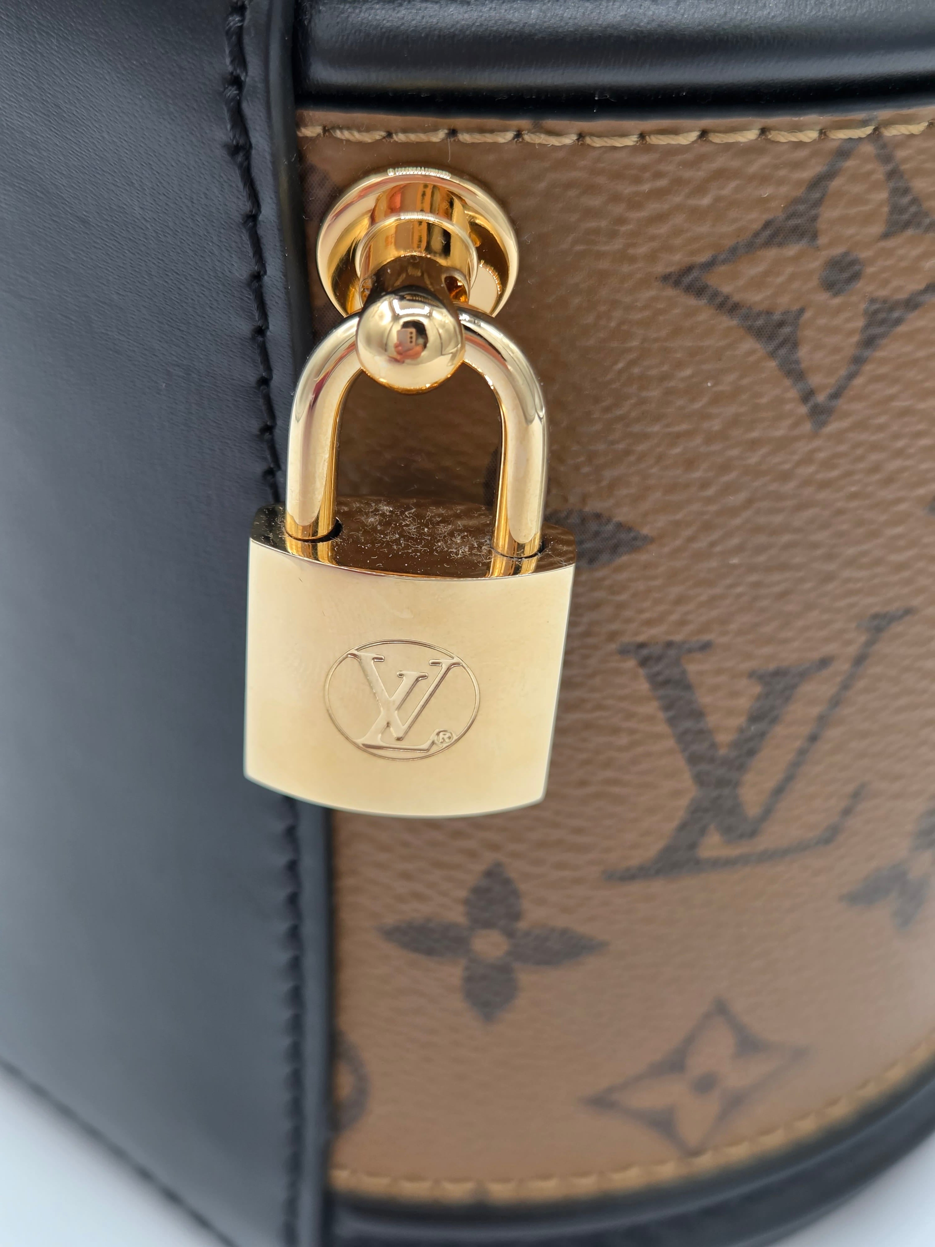 Gold padlock on a Louis Vuitton bag with monogram pattern