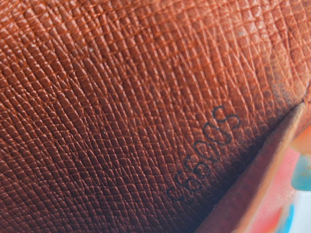 Close-up of a brown textured leather surface with embossed script lettering.