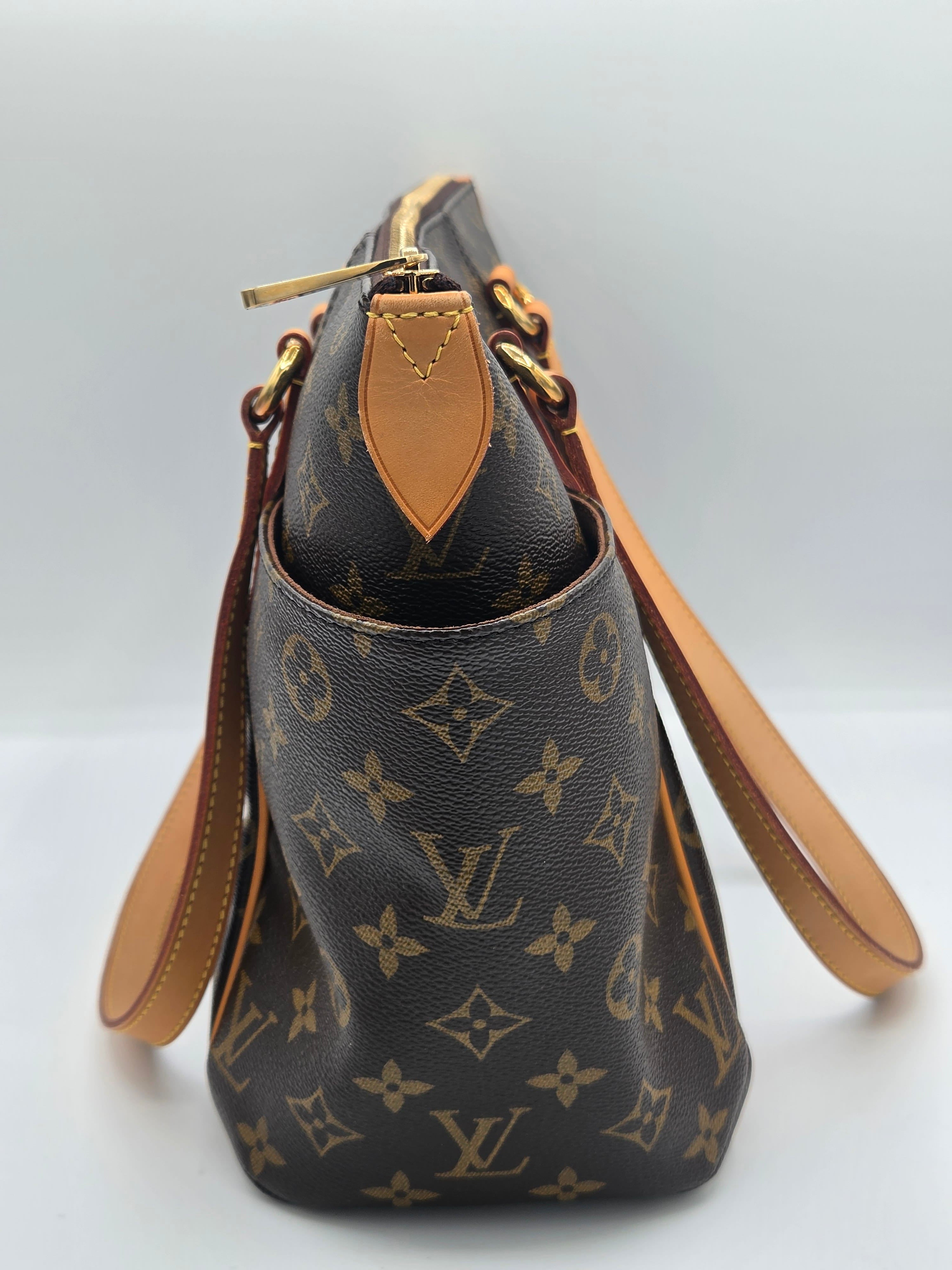 Louis Vuitton monogram canvas shoulder bag in dark brown with tan leather trim and gold-tone hardware, photographed against a light gray studio background.