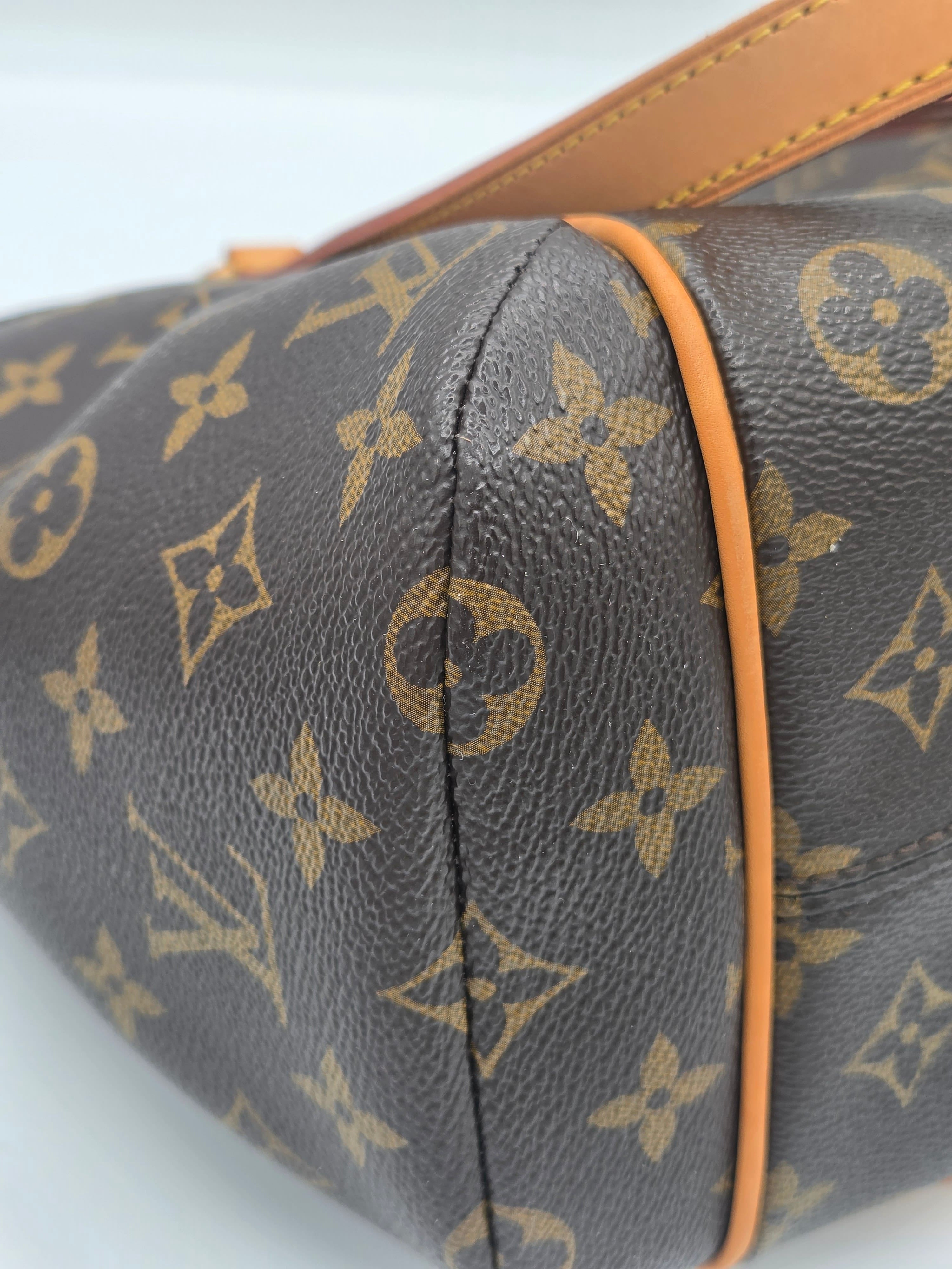 Close-up of a Louis Vuitton monogram canvas bag in dark brown with tan leather trim and a light brown monogram pattern.