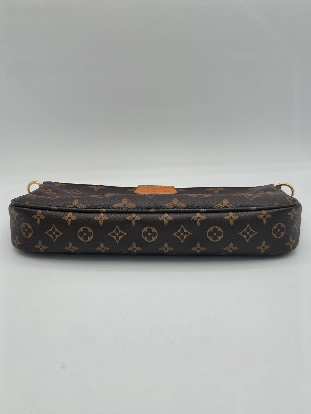 A Louis Vuitton monogram canvas pouch or small bag shown vertically against a plain light gray background.