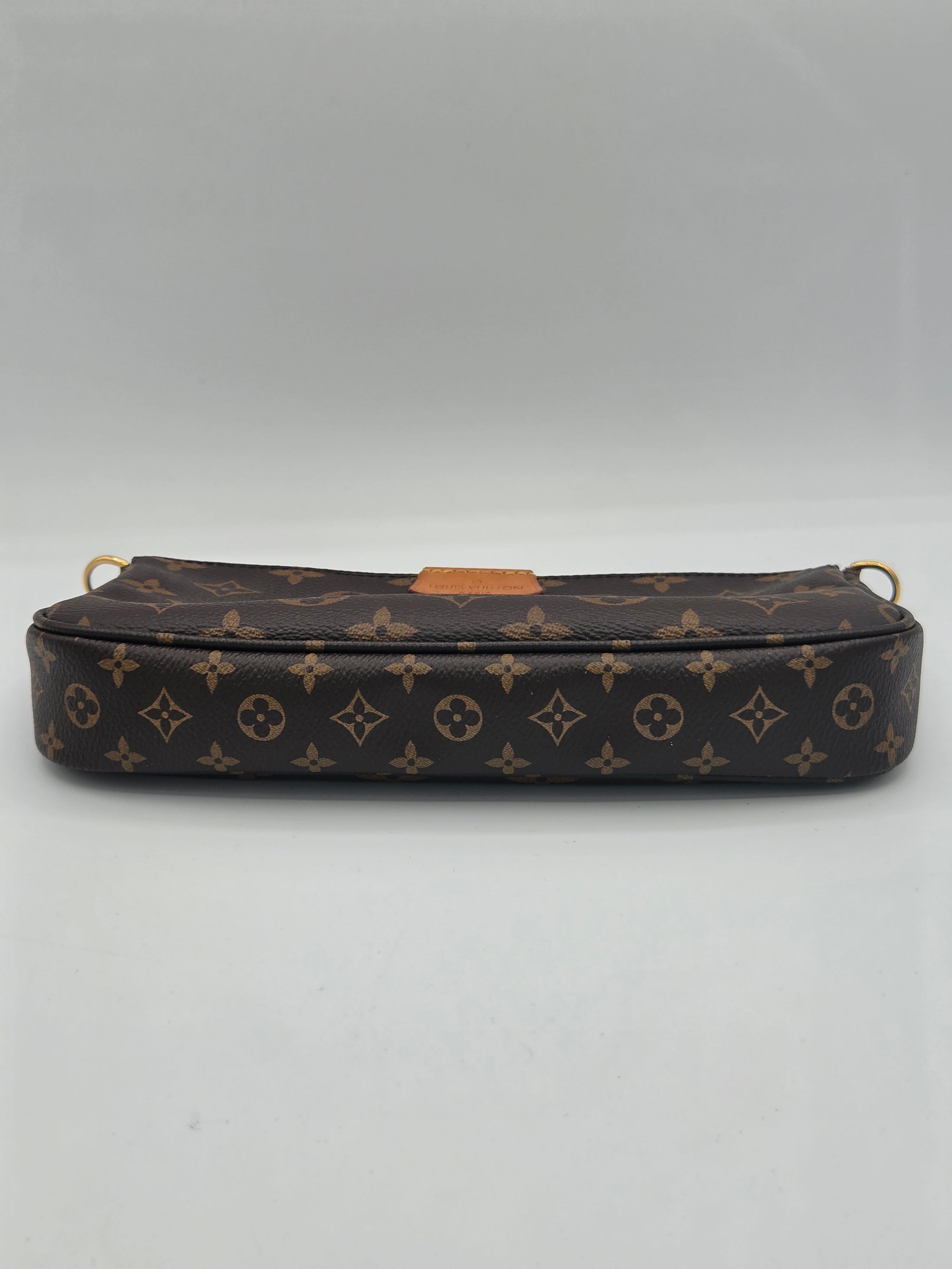 A Louis Vuitton monogram canvas pouch or small bag shown vertically against a plain light gray background.